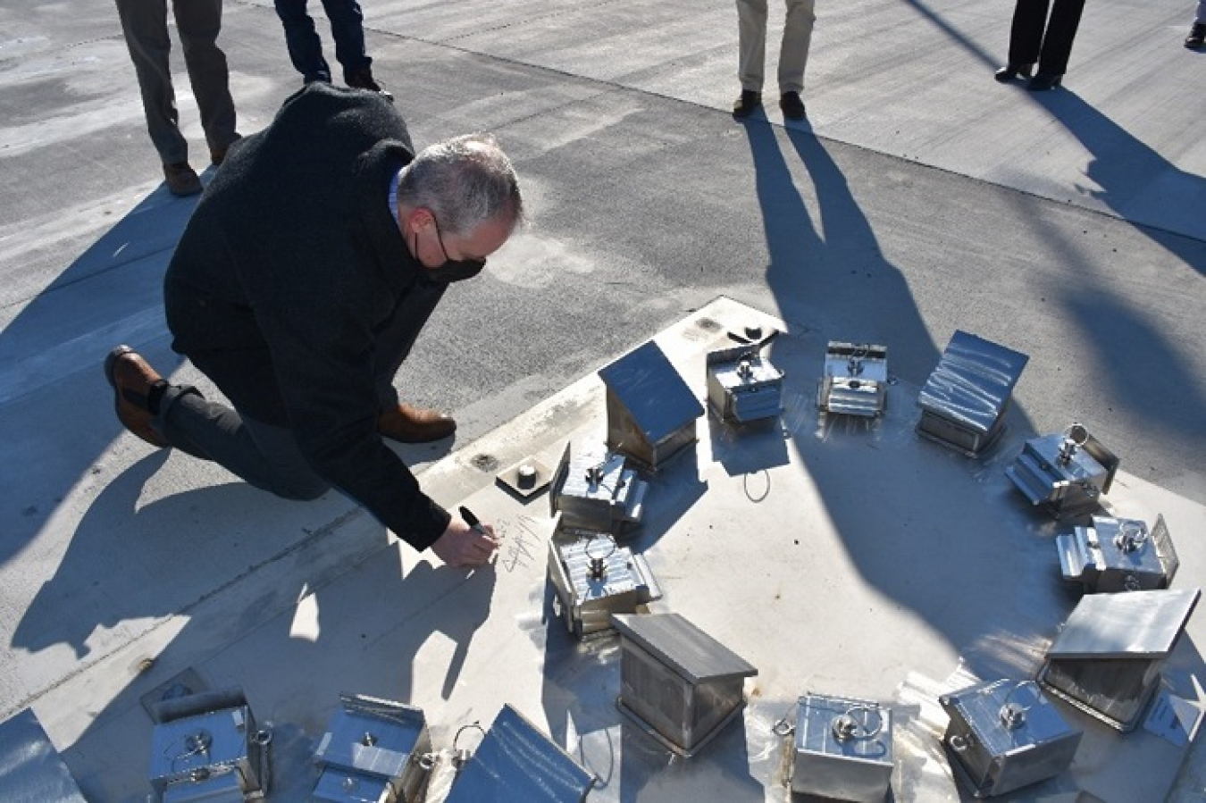 During a Feb. 23 tour of the Hanford Site, EM Senior Advisor William “Ike” White signs the base of a bracket that will securely hold an ion exchange column from the Tank-Side Cesium Removal System used to filter tank waste.