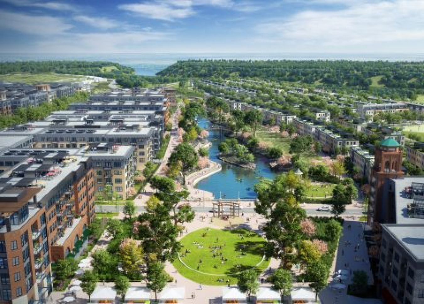 Aerial view of a district of large commercial buildings with a river flowing beside them.