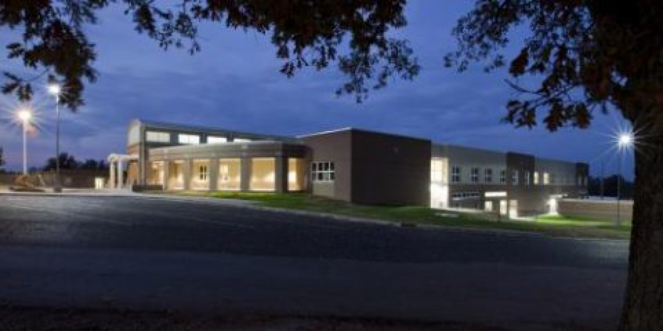 The exterior of the Richardsville School building at either twilight or dusk.