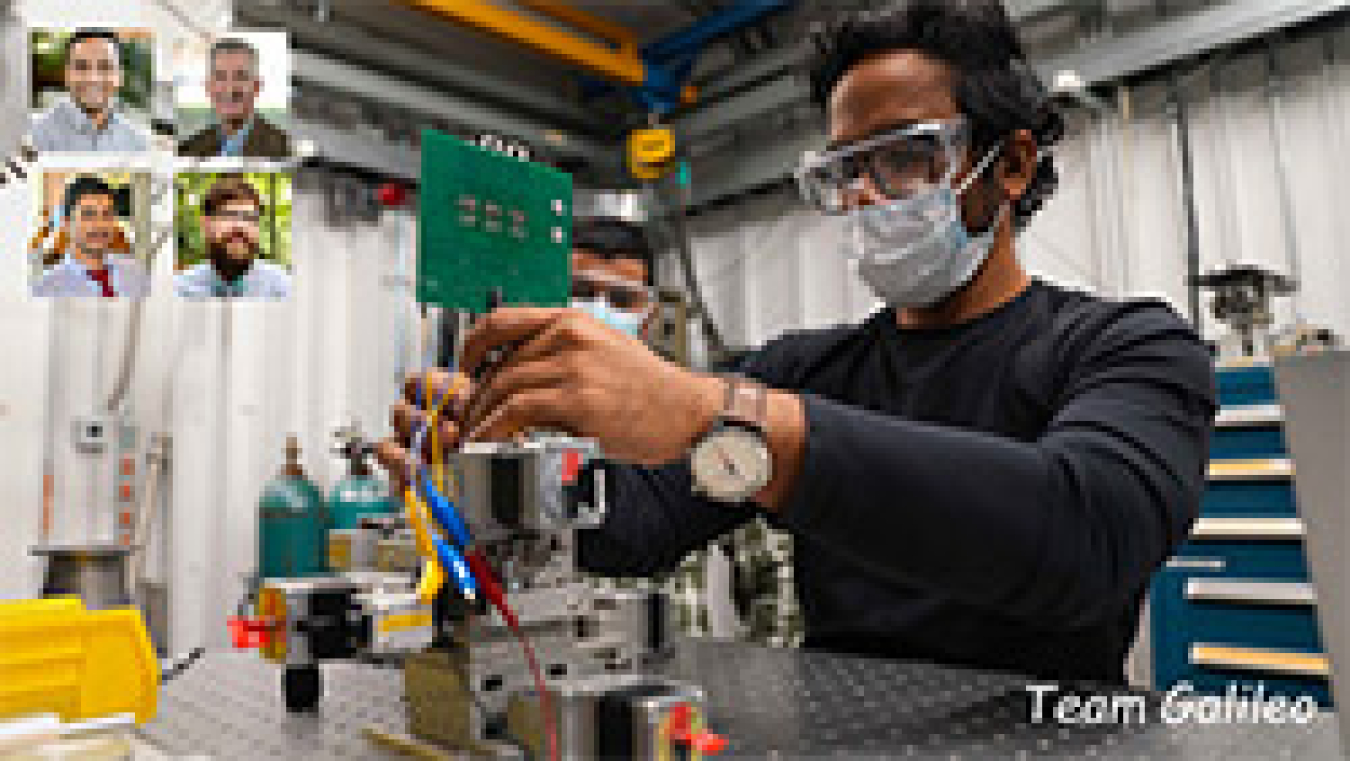 Two men working with lab equipment.