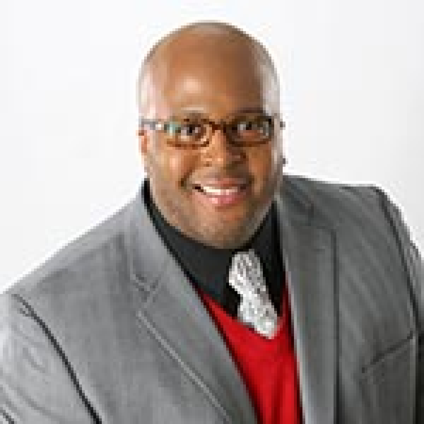 Image of a professional man wearing a suit, vest, and tie