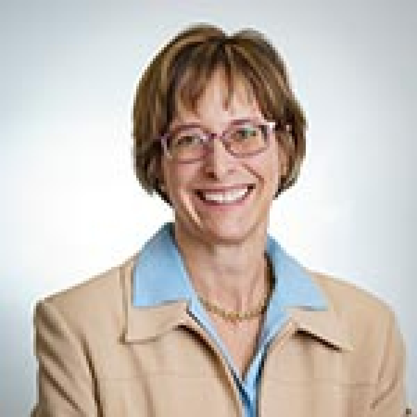 Image of a professional woman wearing a jacket and collared shirt