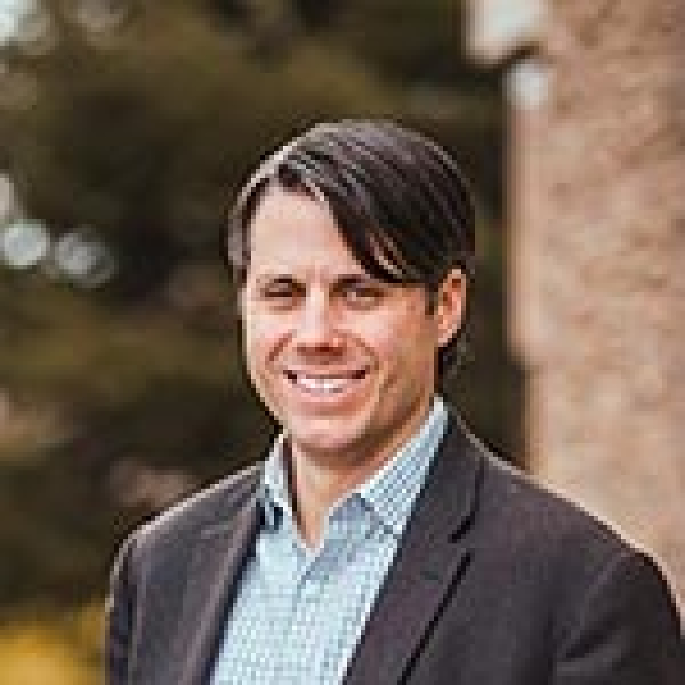 Image of a man wearing a sport coat and collared shirt