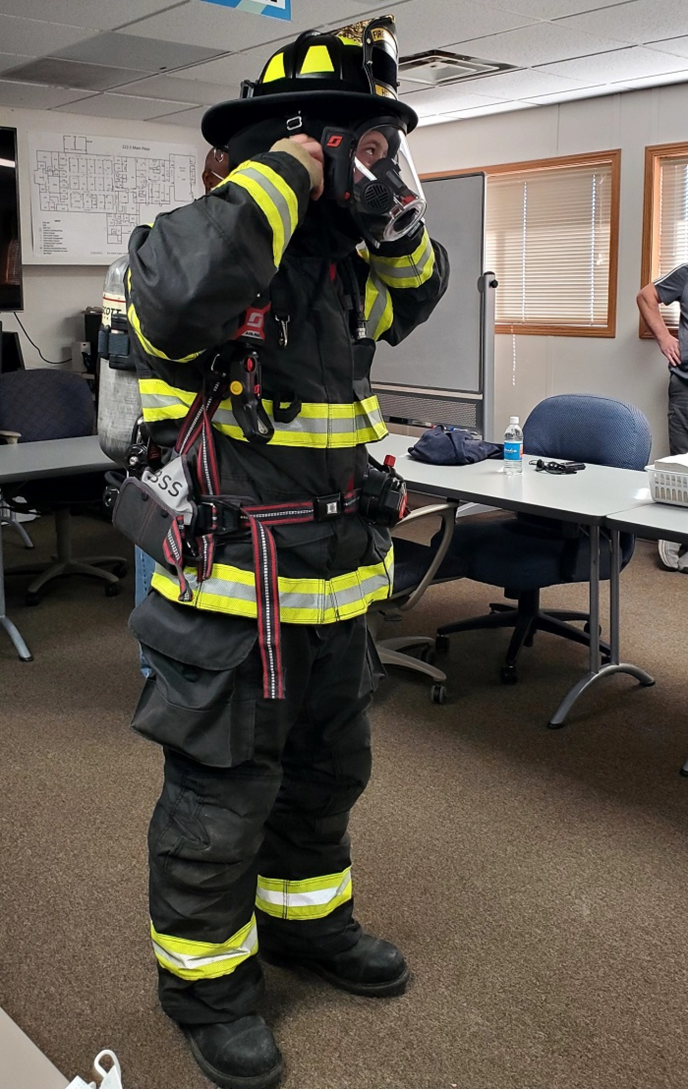 Hanford Site firefighter Chris Helms prepares to remove his gear during a training session with Hanford Laboratory Management and Integration, designed to give facility emergency response support personnel hands-on training.