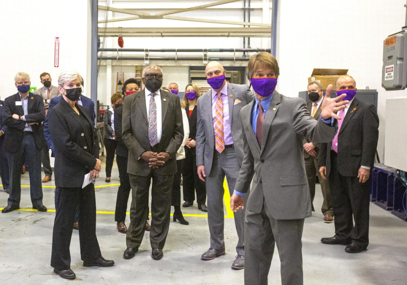 Sec. Granholm, Rep. Clyburn, and Clemson President James P. Clements listen as Dr. E.R. Collins explains what tests are done at the Clemson University wind turbine test facility in North Charleston as they tour the complex on Feb 17. 