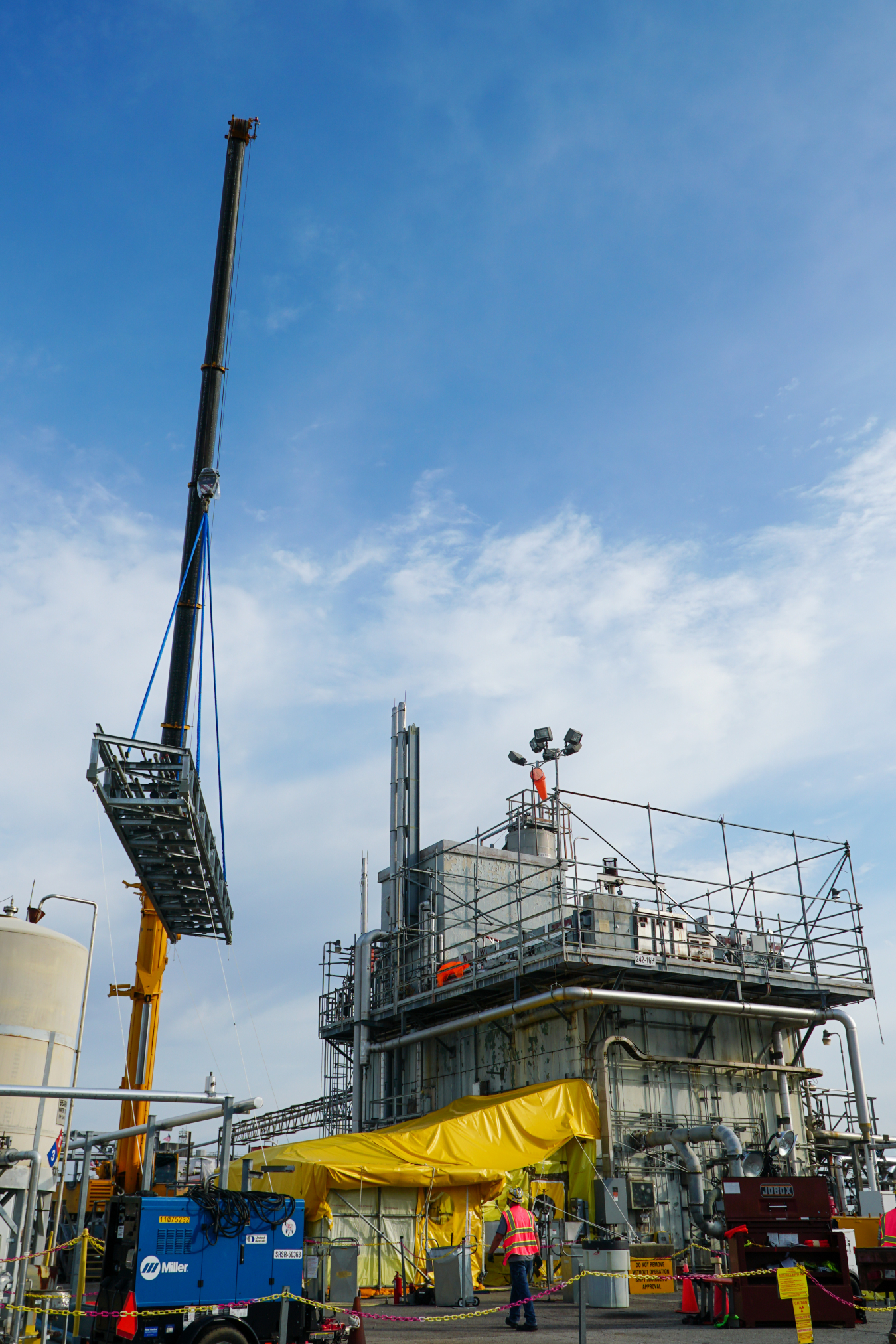 Crews install a new pipe bridge in the Savannah River Site’s H Tank Farm that will transport utility services to 2H Evaporator, pictured, which reduces the volume of liquid radioactive waste in the site's 43 remaining operational tanks.