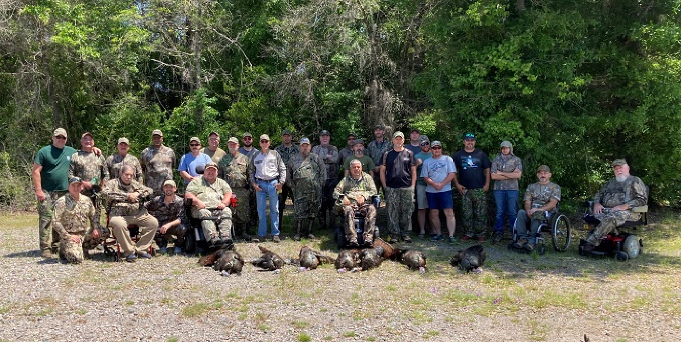 Hunters in the 17th Annual Wounded Warrior and Mobility Impaired Wild Turkey Hunt gather post-hunt. Photo courtesy of the U.S. Department of Agriculture.