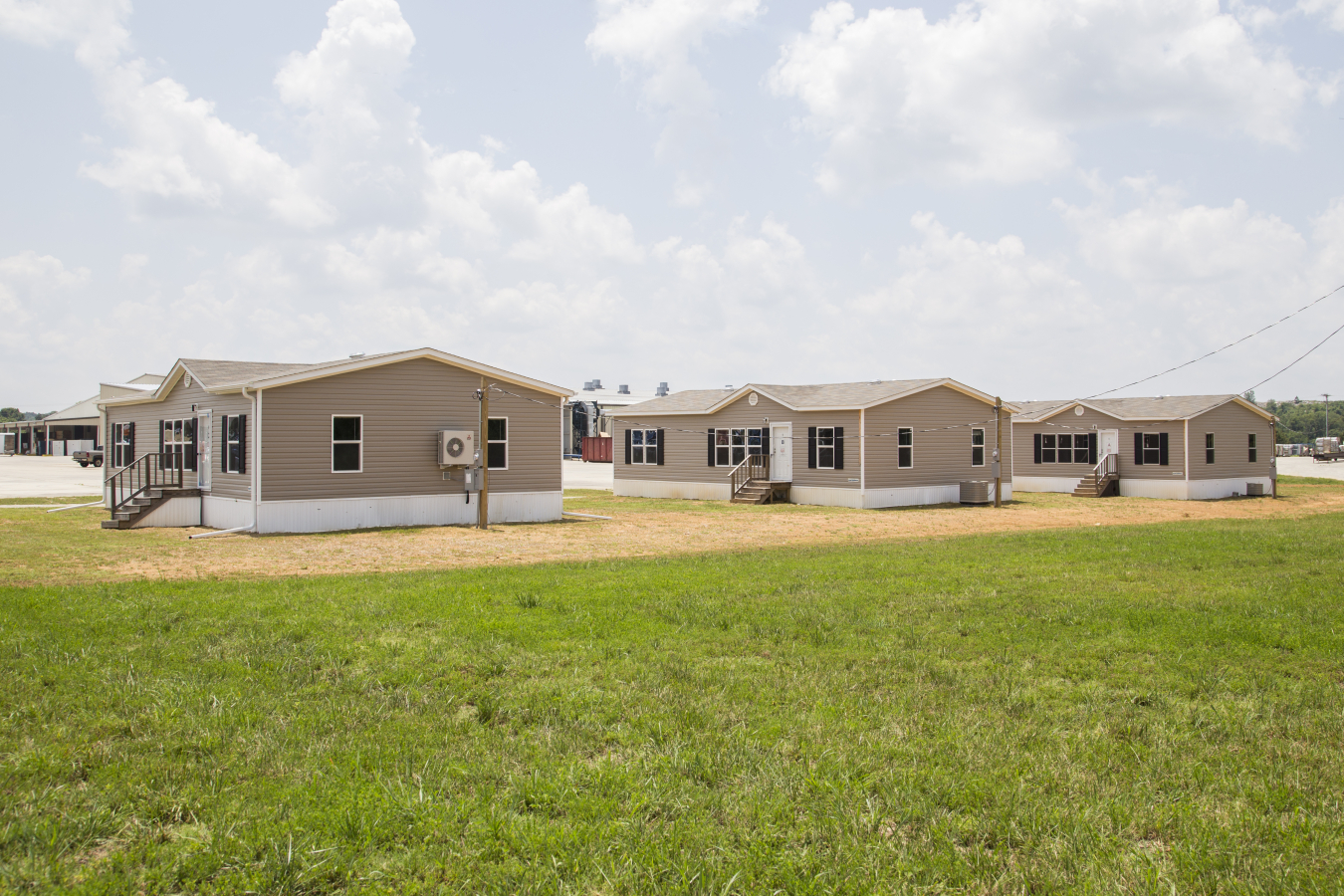 Three similar-looking manufactured homes in a community.