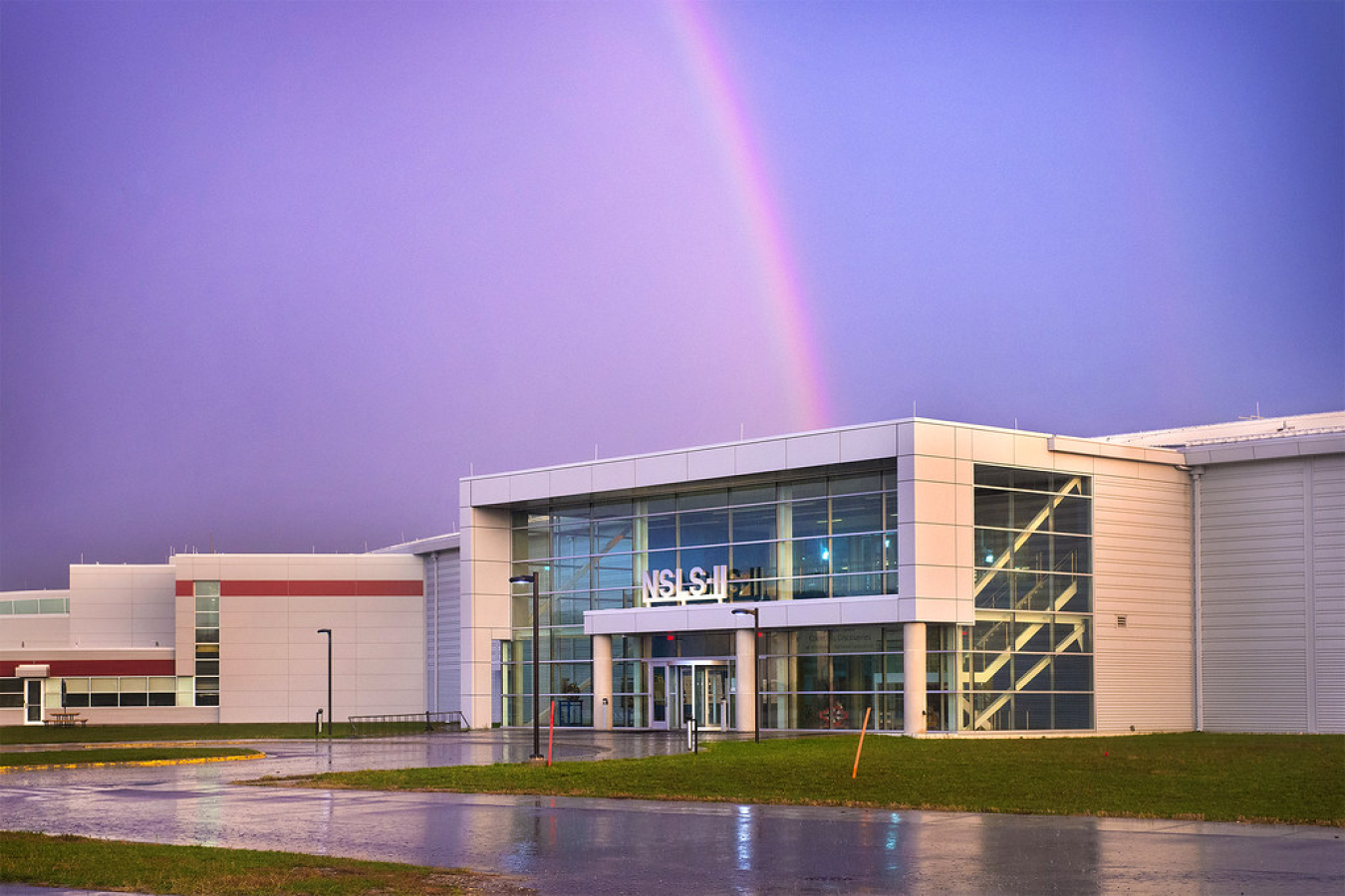 Image of building at the Brookhaven National Laboratory campus with a rainbow in the background