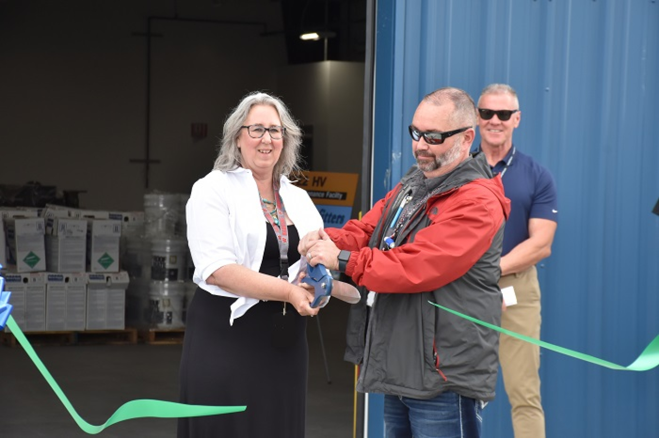 Pam Schreifels and Jason Green cut the ribbon at the new Multi-Craft Maintenance Facility on the Hanford Site.