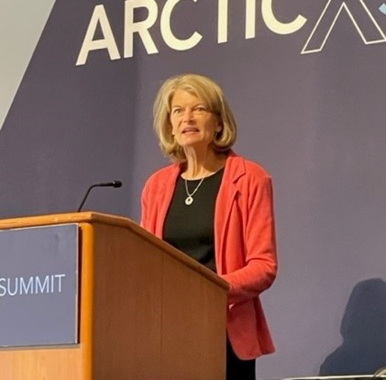 Senator Lisa Murkowski stands at the podium at ArcticX.