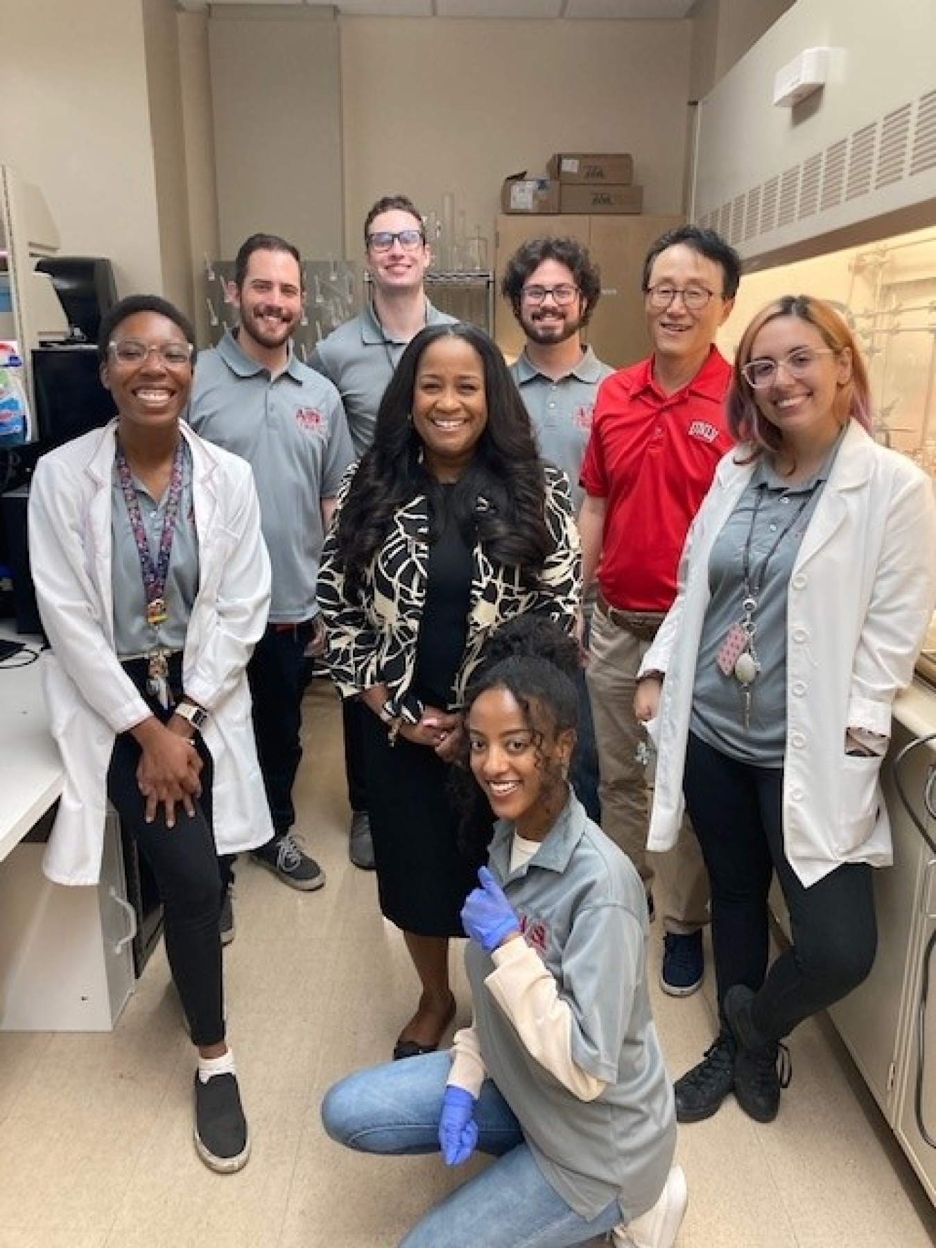 EM Associate Principal Deputy Assistant Secretary for Field Operations Nicole Nelson-Jean is surrounded by student researchers and their professor in the Active Materials and Smart Living Laboratory at the University of Nevada, Las Vegas. Clockwise from left: Alexandrea Washington; Blake Naccarato; Daniel Fisher; John Faccinto; Professor Kwang Kim; Nazanin Minaian; and Liya Napollion.