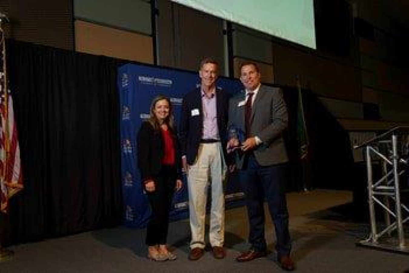 Tri-City Regional Chamber of Commerce Board members Andy Stirling, right, and Trish Herron, left, presented the “Business on a Roll Award” to Rick Moren, center, senior program manager for the North Wind Solutions Hanford-Richland Office.