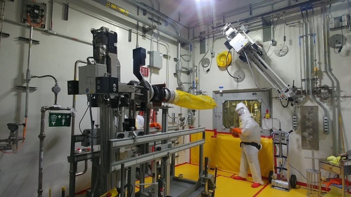 A worker replaces a manipulator arm at the Salt Waste Processing Facility.