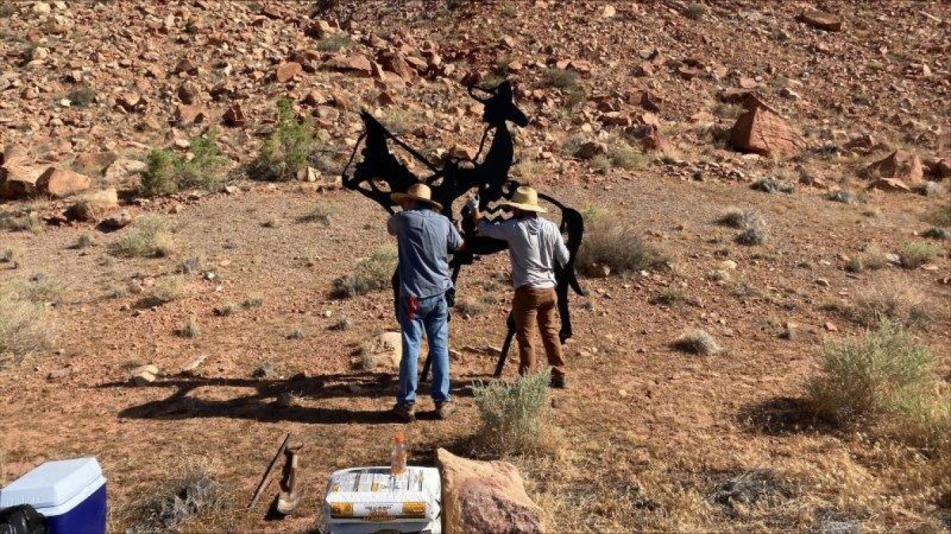 Members of the Canyonlands Back Country Horsemen group help place one of the art silhouettes. 