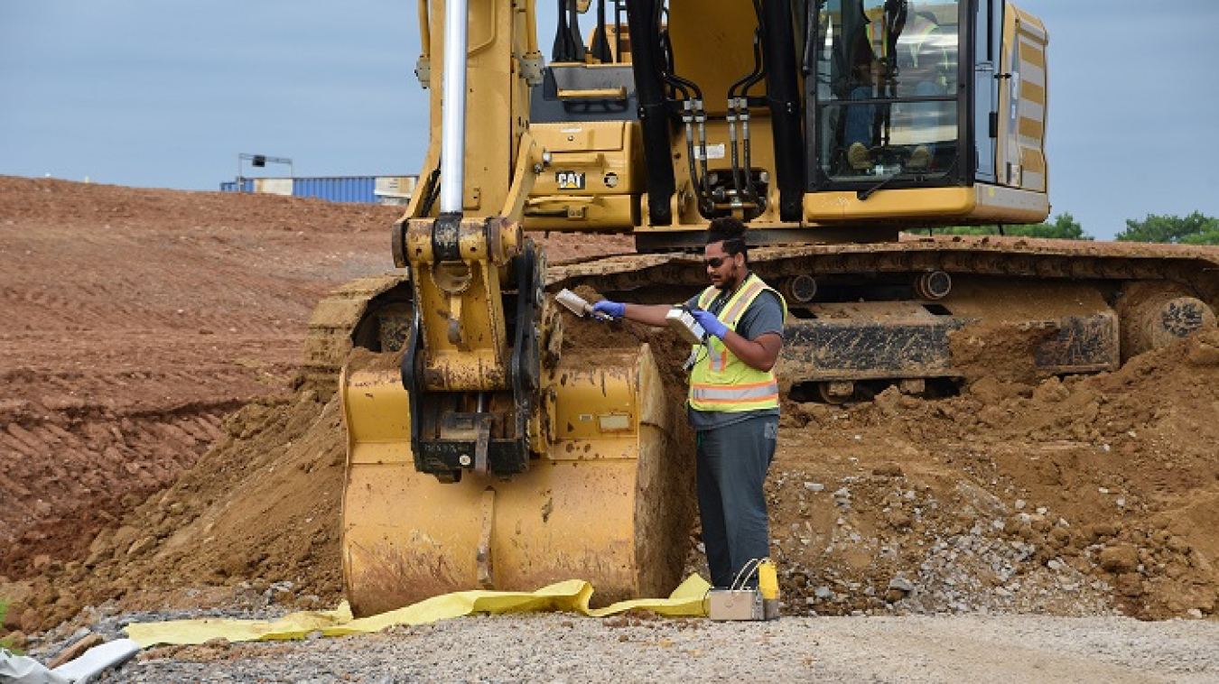 A worker scans excavated soil at the former K-25 building site at Oak Ridge to ensure it contains no radioactive contaminants.