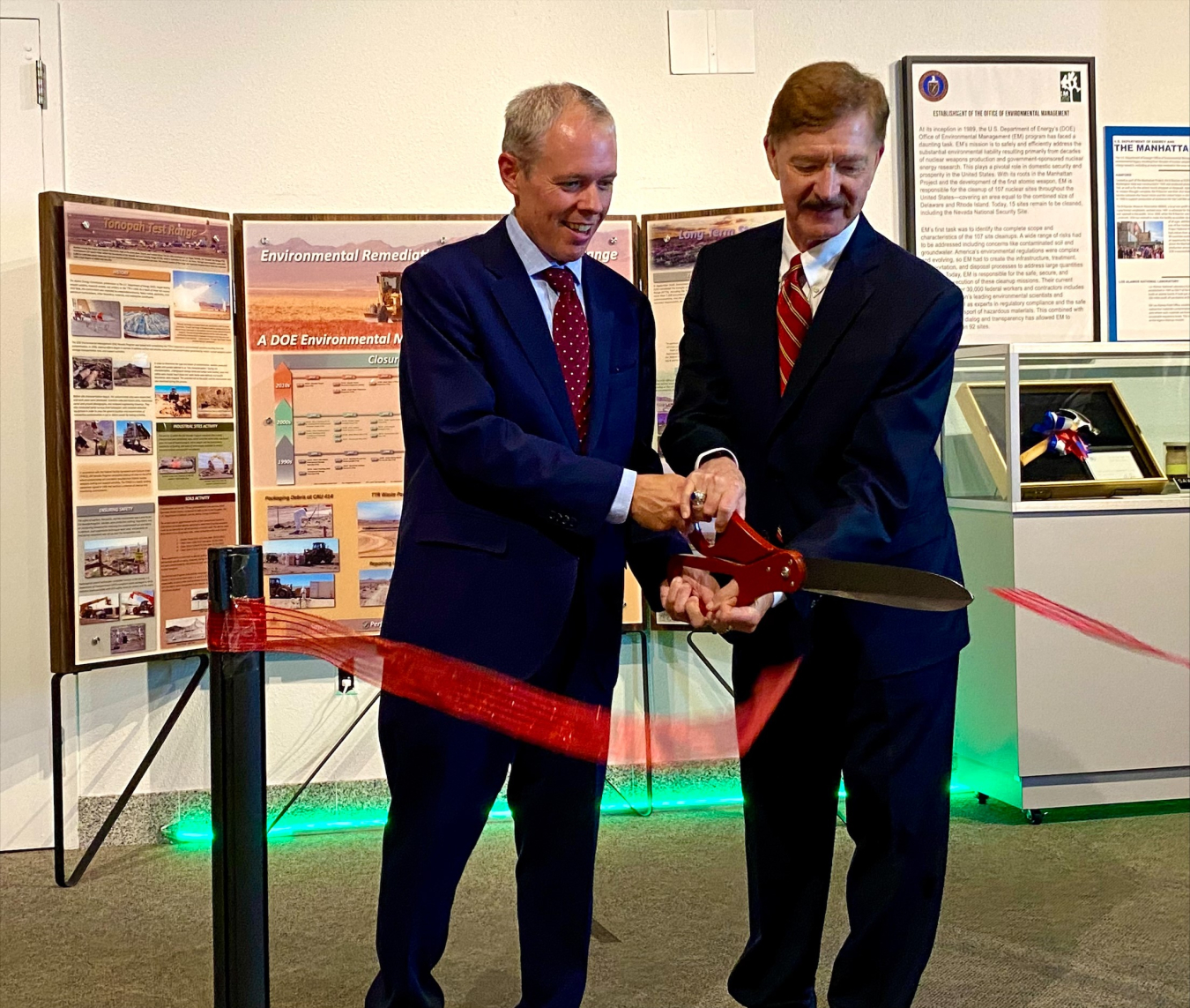 EM Senior Advisor William "Ike" White, left, and John Longenecker, chair of the Nevada Test Site Historical Foundation, cut a ceremonial ribbon to celebrate the opening of EM's new permanent exhibit at the National Atomic Testing Museum in Las Vegas Aug. 2.