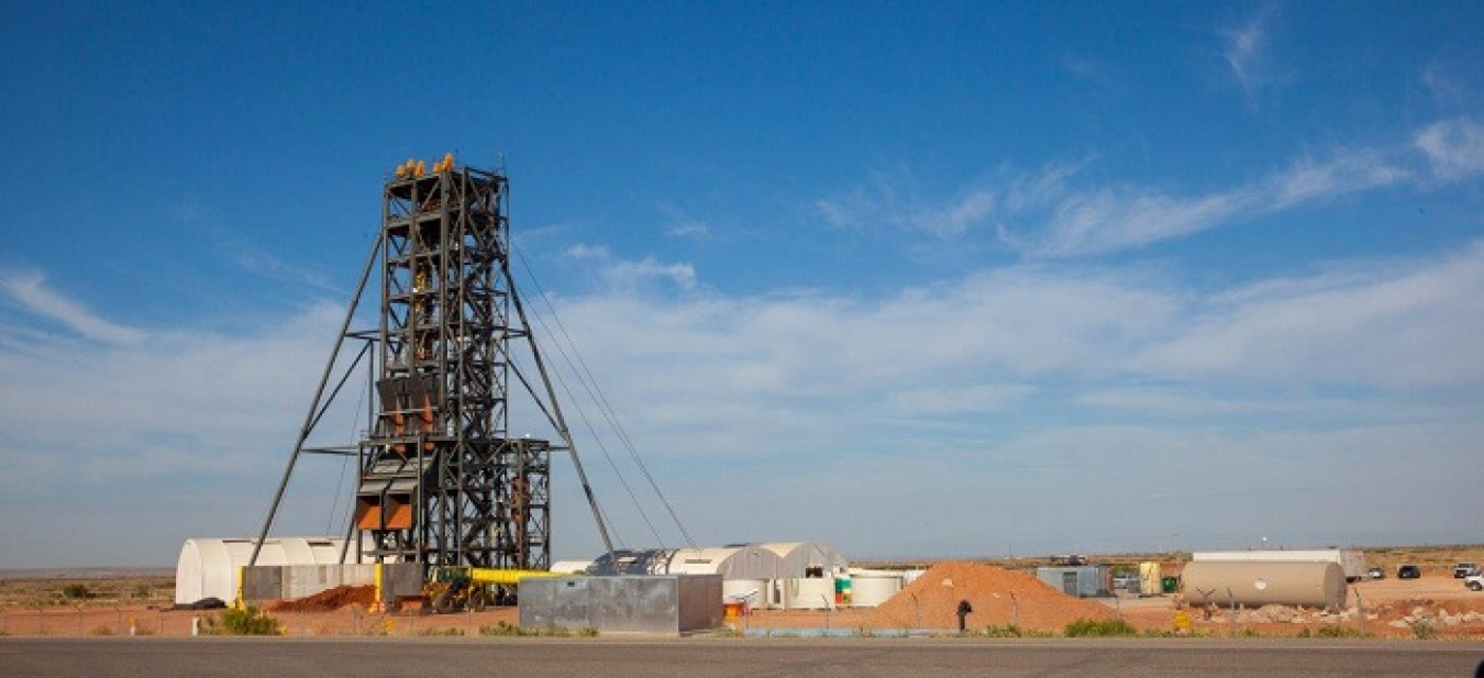 A view of the headframe over the top of the Waste Isolation Pilot Plant (WIPP) Utility Shaft being excavated. Two shoots can be seen near the base of the headframe. 