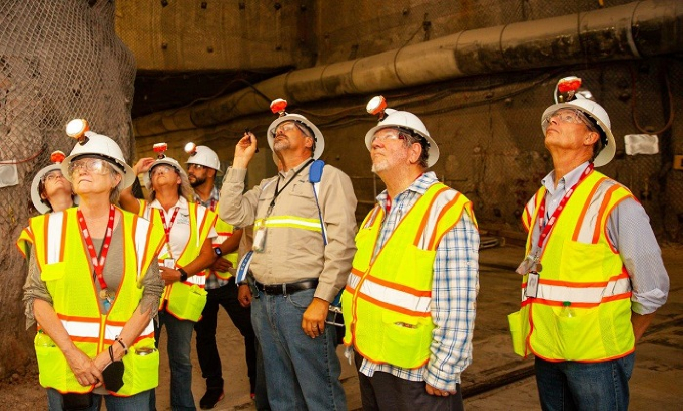 Nuclear Waste Partnership Chief Operating Officer Mark Pearcy, middle, shines a laser pointer on bolts in the roof, or back, of the Waste Isolation Pilot Plant underground, 2,150 feet below the surface.