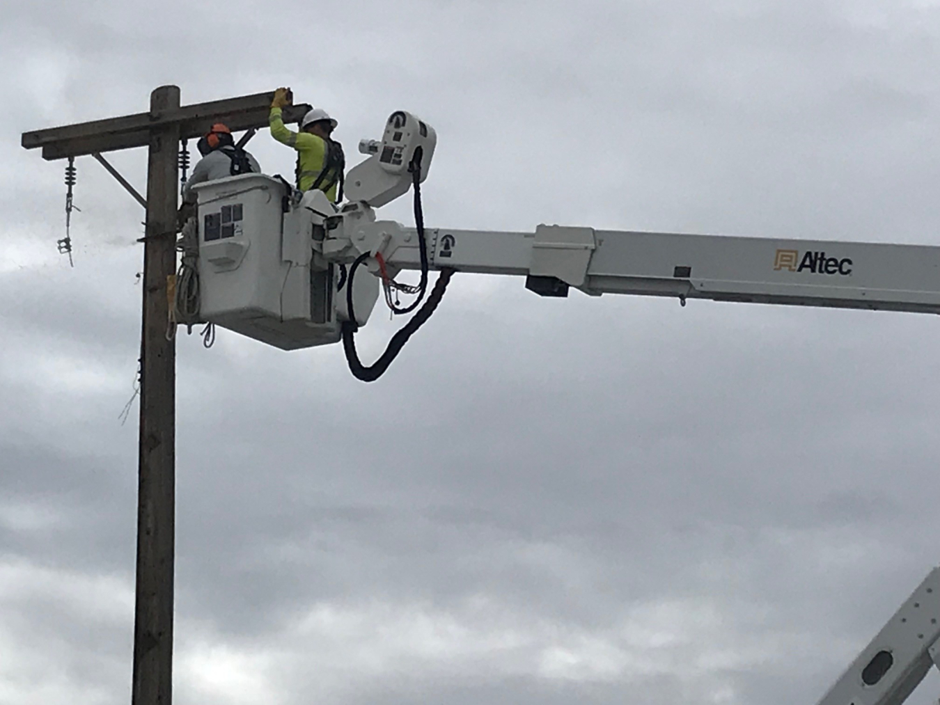 Hanford Mission Integration Solutions staff members Todd Freeland, left, and Adam Wittner disconnect electrical connections to facilities that once supported the former Plutonium Finishing Plant at the Hanford Site.