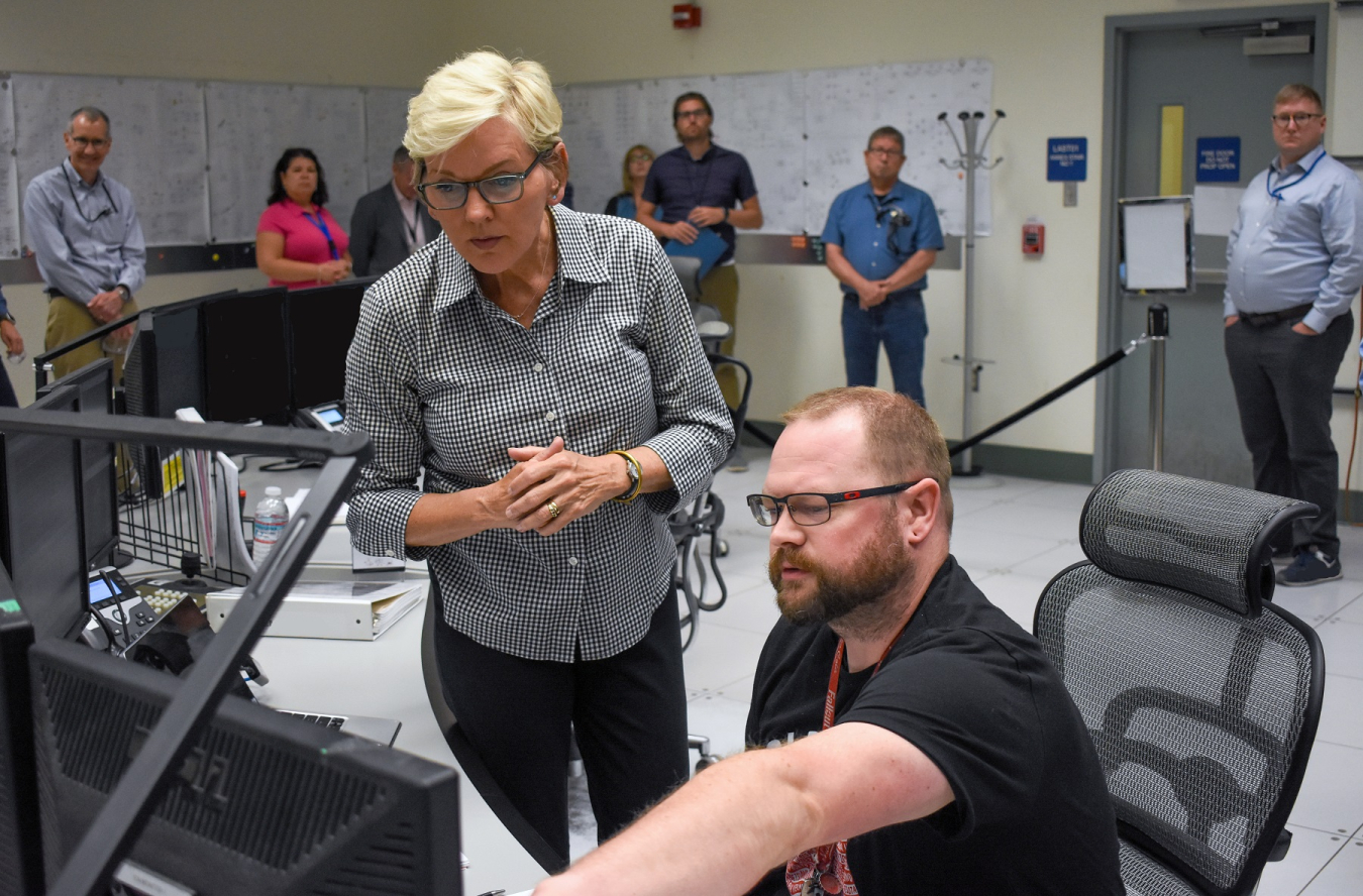 Commissioning Technician Alex Flint briefs Energy Secretary Jennifer Granholm on the equipment and systems he monitors, manages and operates from his watch station at the Low-Activity Waste Facility at the Waste Treatment and Immobilization Plant.