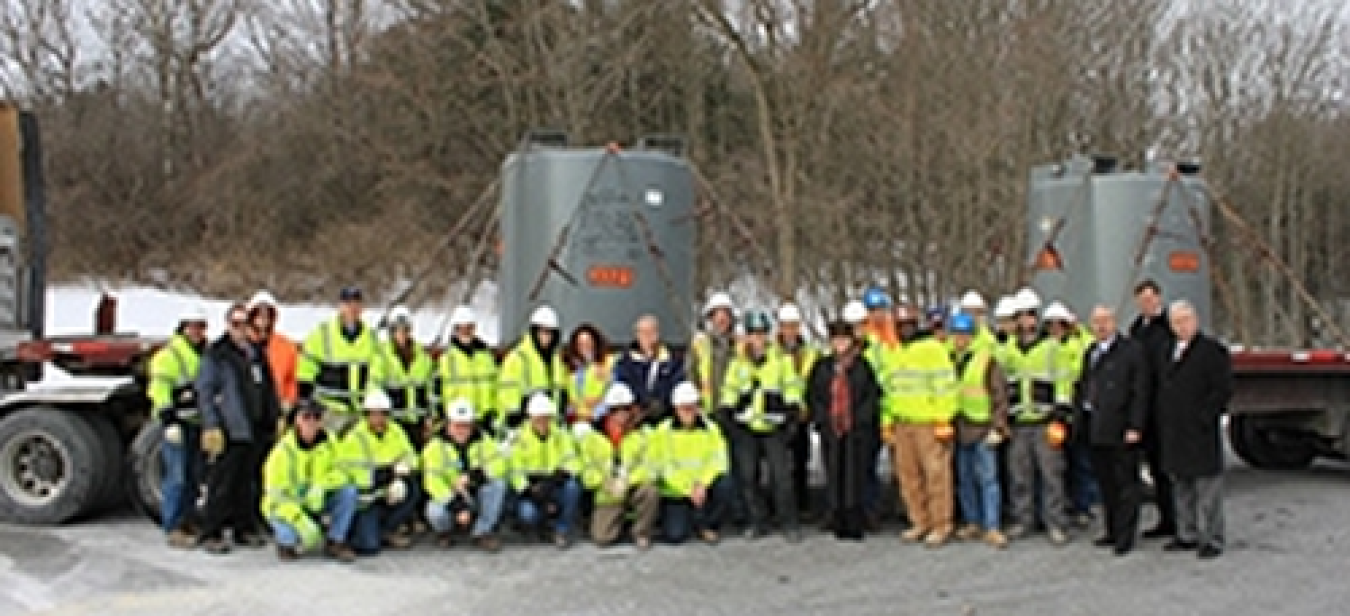 Crews gather in front of the last shipment of solidified tank heels from Building H2's tank vaults in 2014. The tank heels contained approximately 85 percent of the radiological inventory in Buildings G2 and H2.