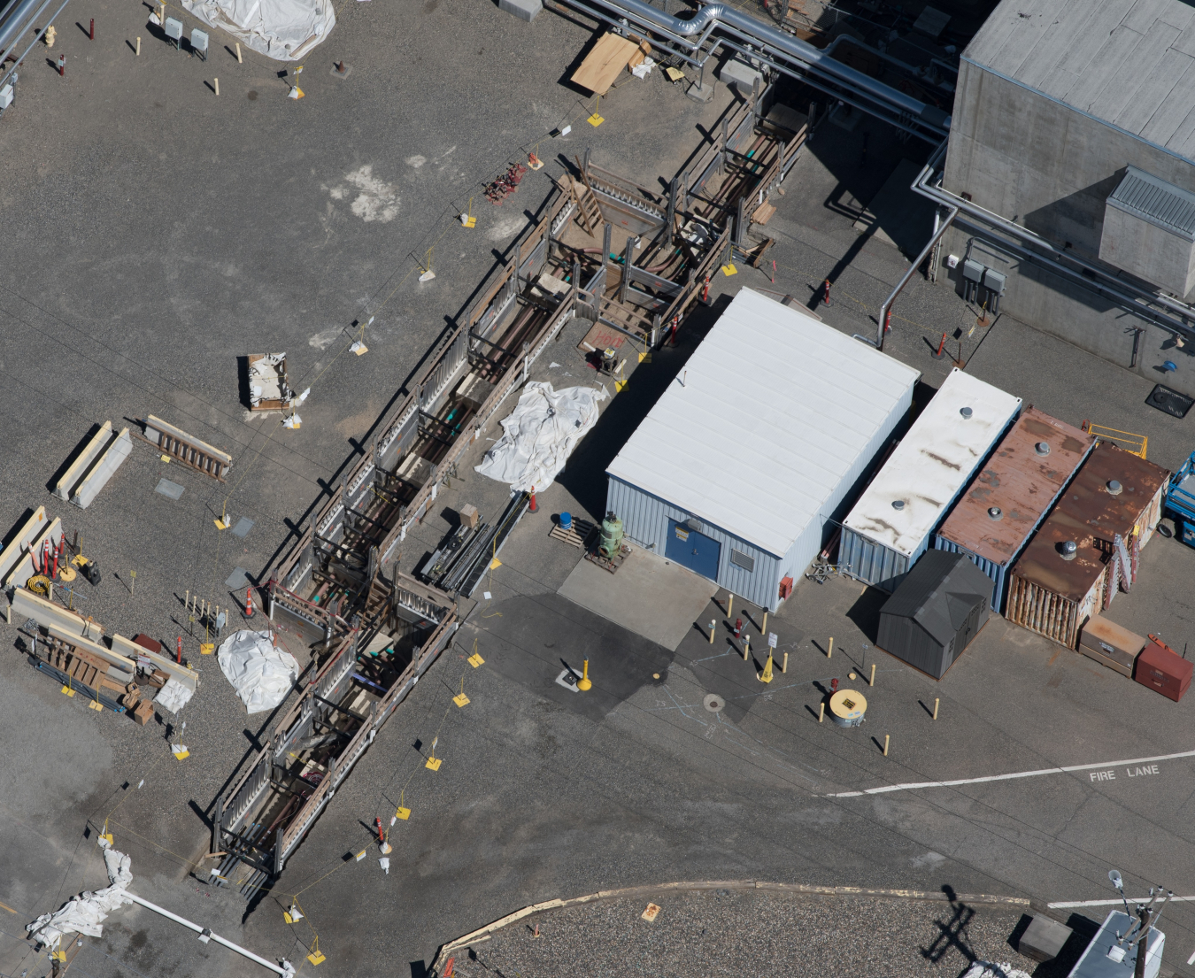 This aerial photo shows trenches dug for the replacement of approximately 1,300 feet of piping between the 242-A Evaporator and an adjacent tank waste storage area near the center of the Hanford Site.