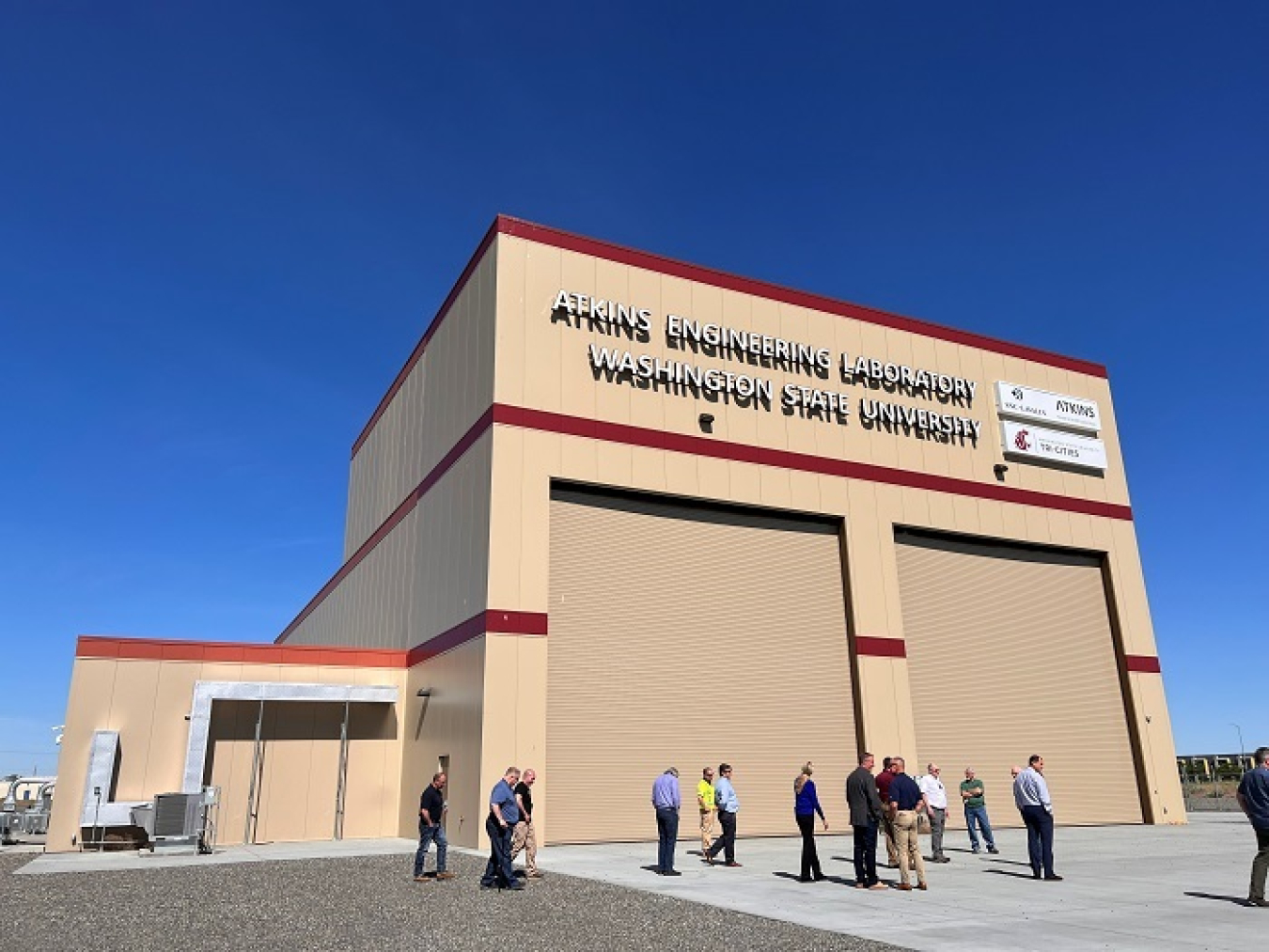 Representatives from the Office of River Protection and broader DOE tour the Low-Activity Waste Melter Assembly, Storage and Transportation facility near the Hanford Site prior to the installation of steel rails outside of the bay doors.