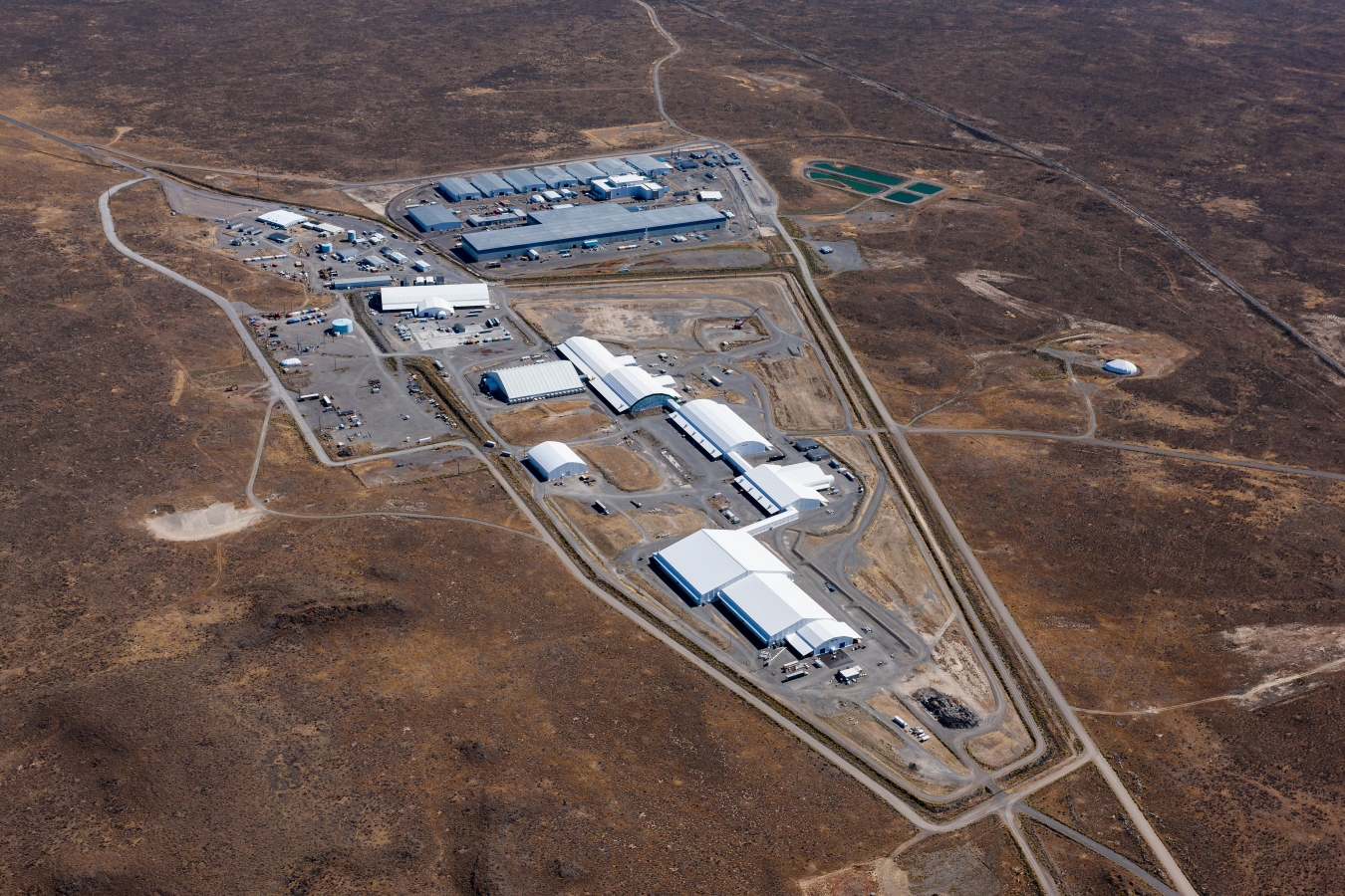 The Subsurface Disposal Area, foreground, at the Idaho National Laboratory (INL) Site will undergo a significant transformation over the next two years. EM and its INL Site contractor are set to demolish the soft-sided Accelerated Retrieval Project buildings to prepare the Cold War-era landfill for its end state.