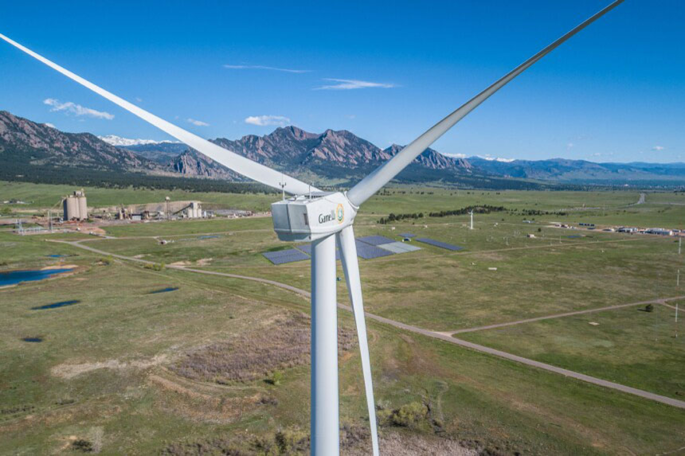 A view of the back side of a wind turbine from the air.