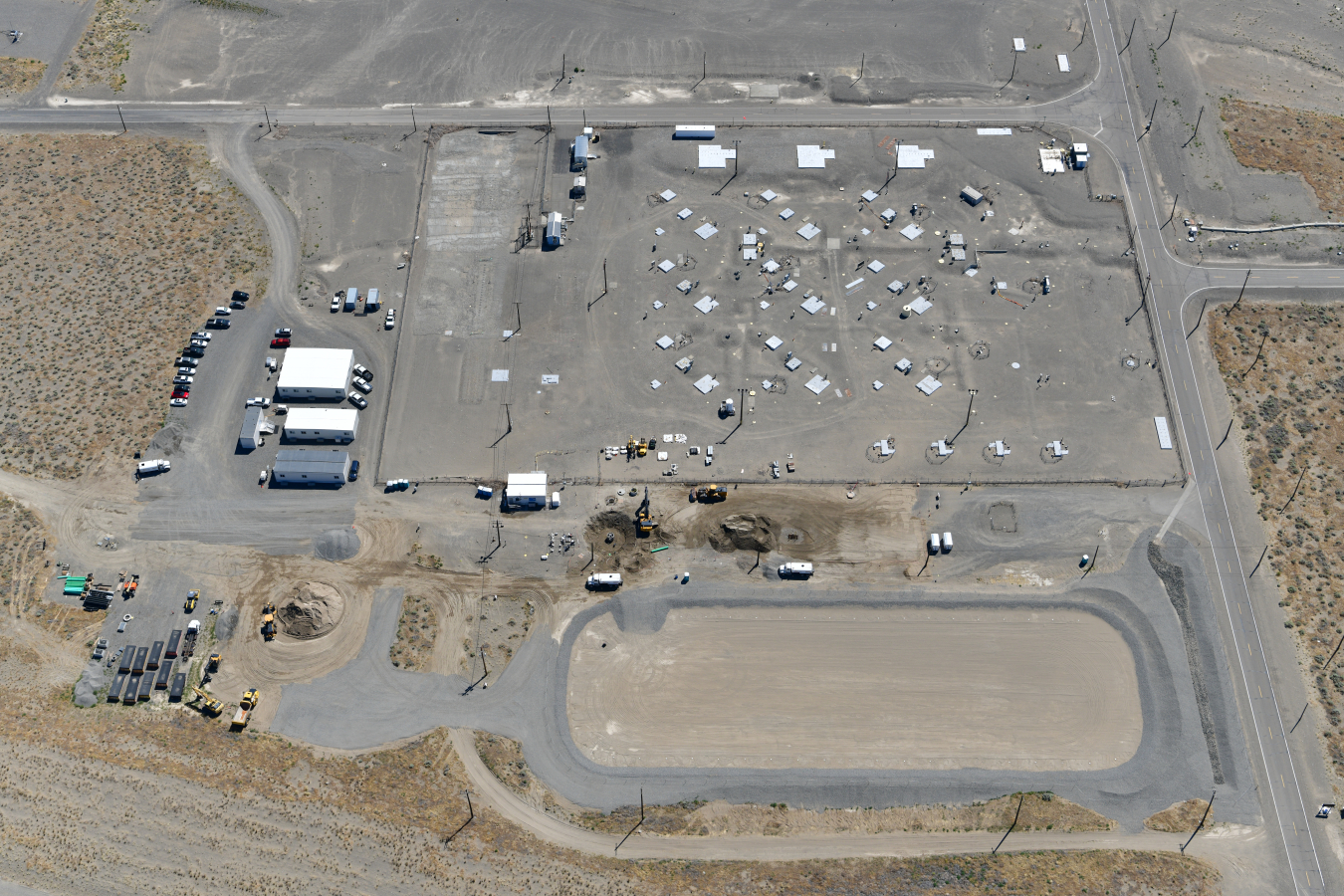 An aerial view of the U Farm, at top, in the 200 West Area of the Hanford Site shows the recently completed lined basin situated below the tank farm.