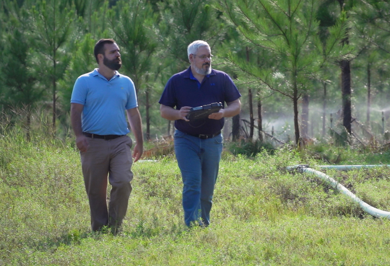 Savannah River National Laboratory Engineer Peter Avioli, left, and Jeff Thibault, an engineer with Savannah River Nuclear Solutions, inspect the Savannah River Site’s phytoremediation project. 