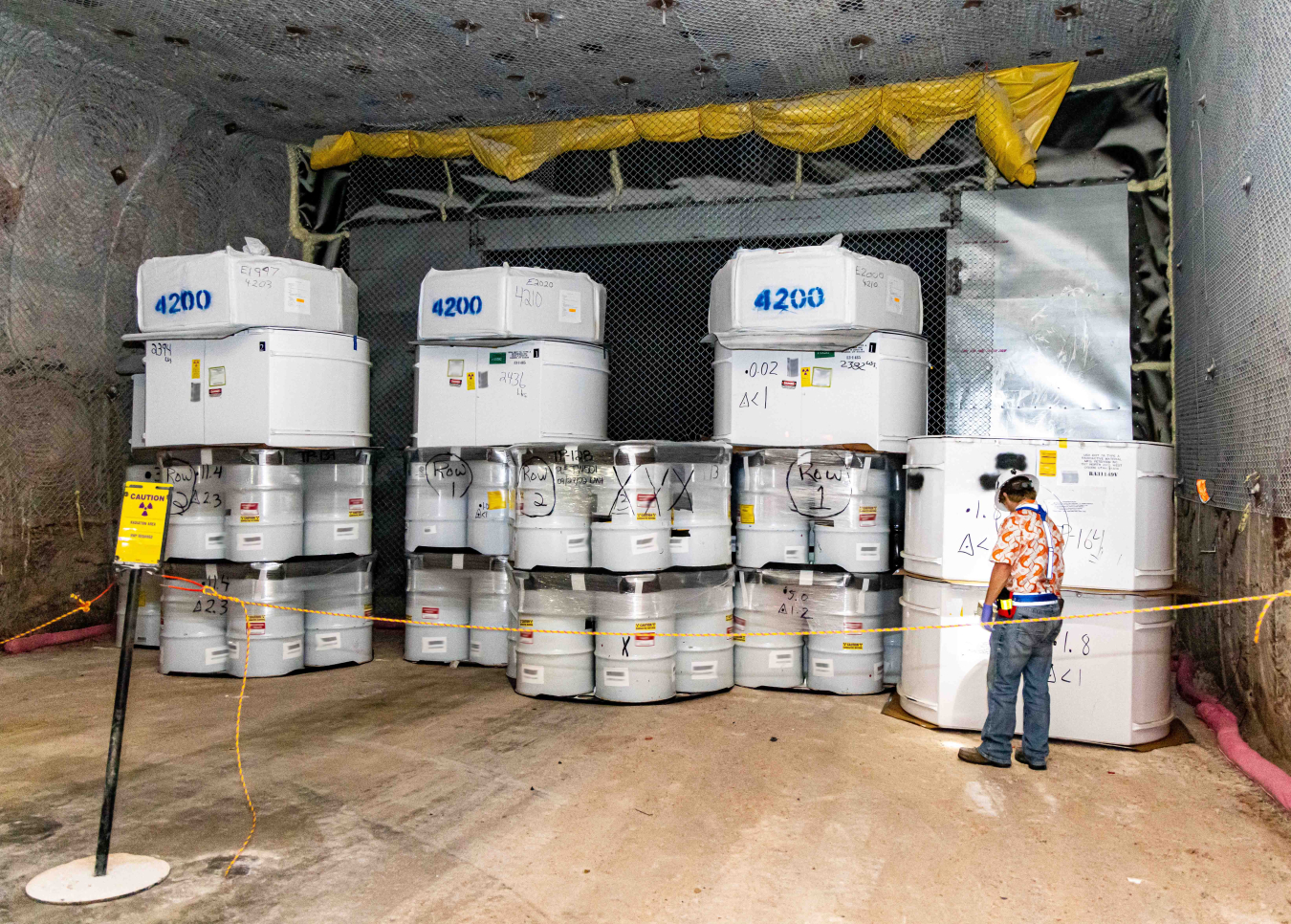 A radiological control technician checks radiation readings on waste containers in Room 6 of Panel 8 at the Waste Isolation Pilot Plant. Employees successfully emplaced the first defense-related transuranic waste in the panel earlier this month.