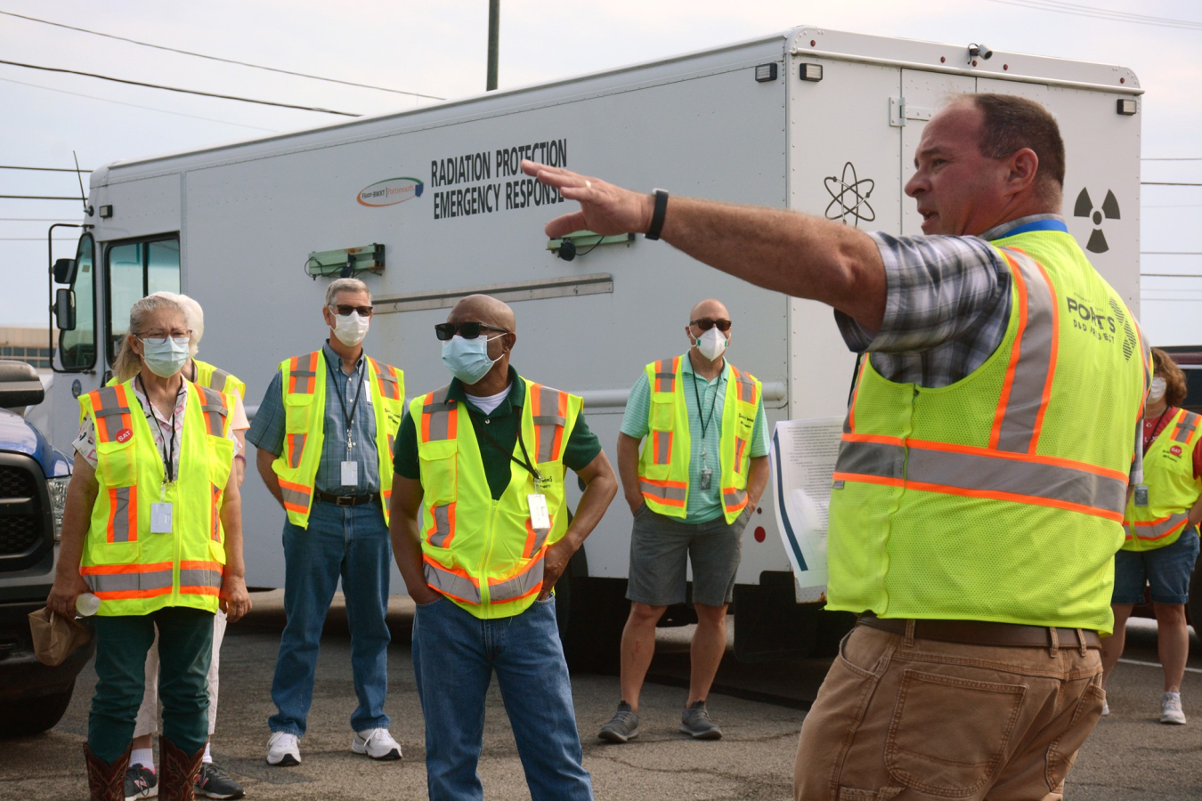 X-326 Process Building Demolition Project Director Mike Furner, right, talks to a tour group in July about progress being made on cleanup efforts at the former Portsmouth Gaseous Diffusion Plant.