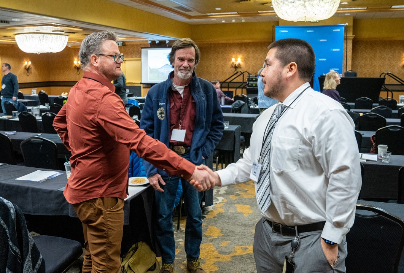 Two men shake hands at the 2022 Program Review.