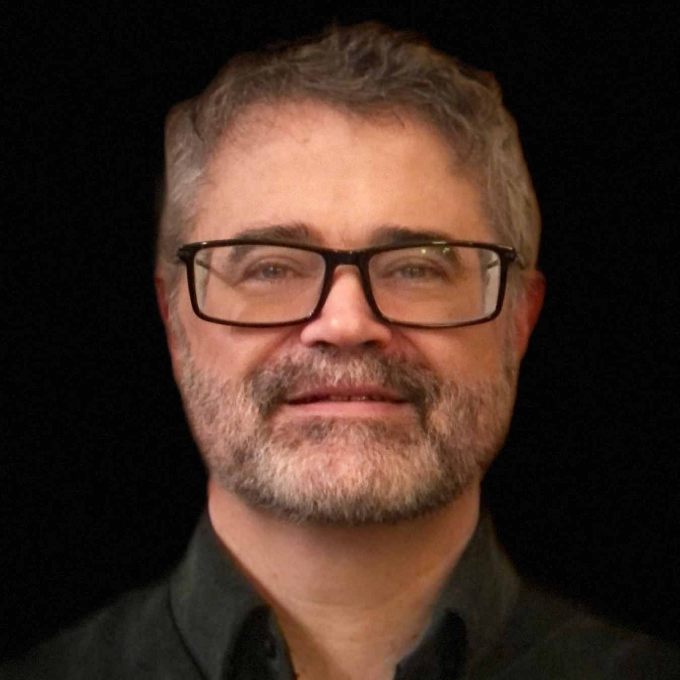 Headshot of a man smiling.