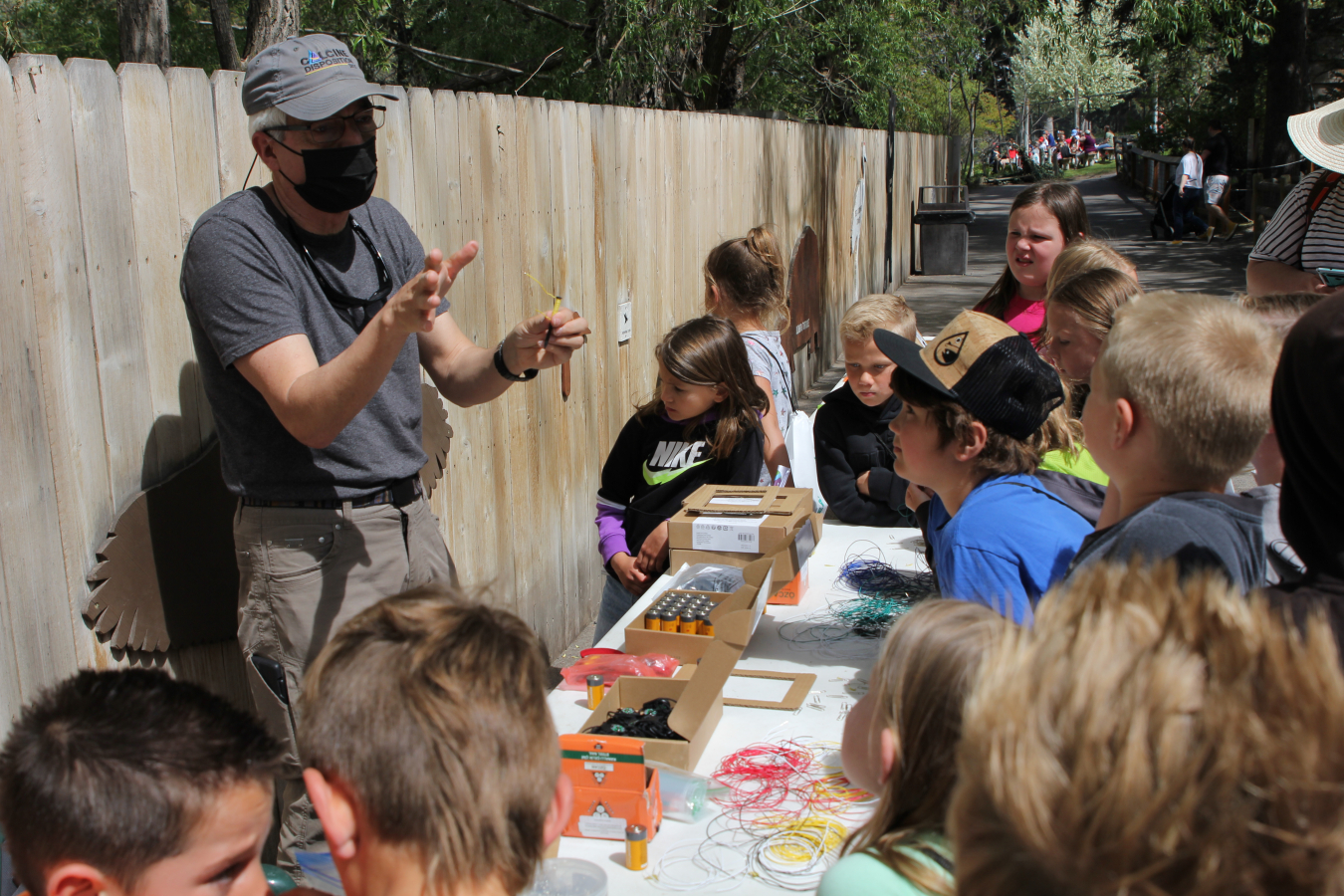 Idaho Environmental Coalition engineer Kevin Young instructs students how to make an electromagnet at STEAM Day at the Idaho Falls Zoo earlier this year.