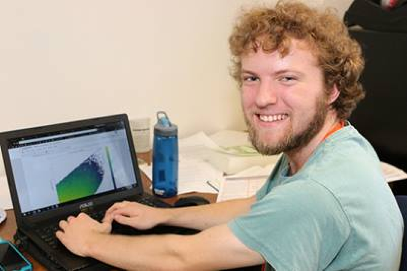 Ross Dempsey working on a laptop.