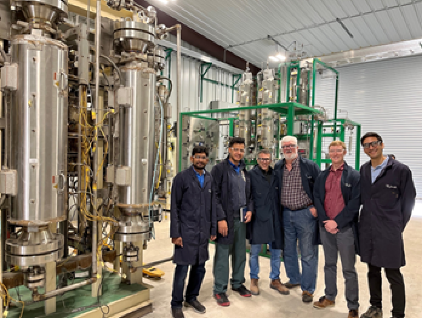 Scientists from ORNL, Pyran, and RPD Technologies pose in front of the pilot-scale reactor testbed. Photo courtesy of ORNL.