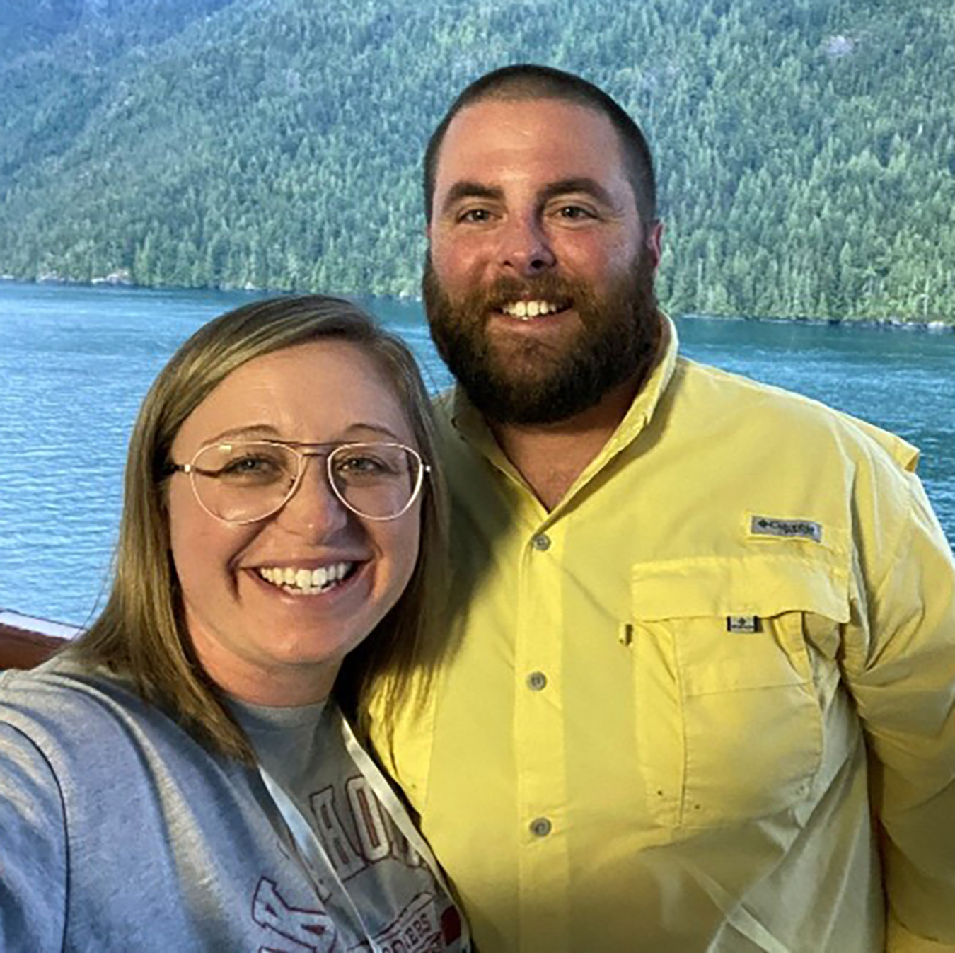 Jacob Long and his wife with a body of water and trees in the background