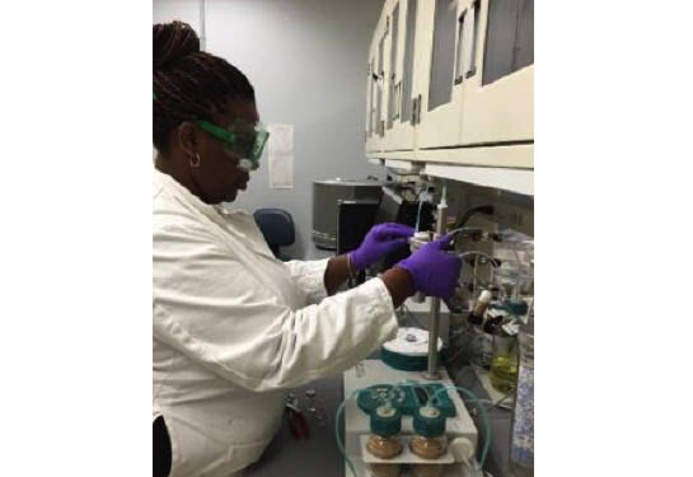 Chietha Moore working in a lab with laboratory equipment.