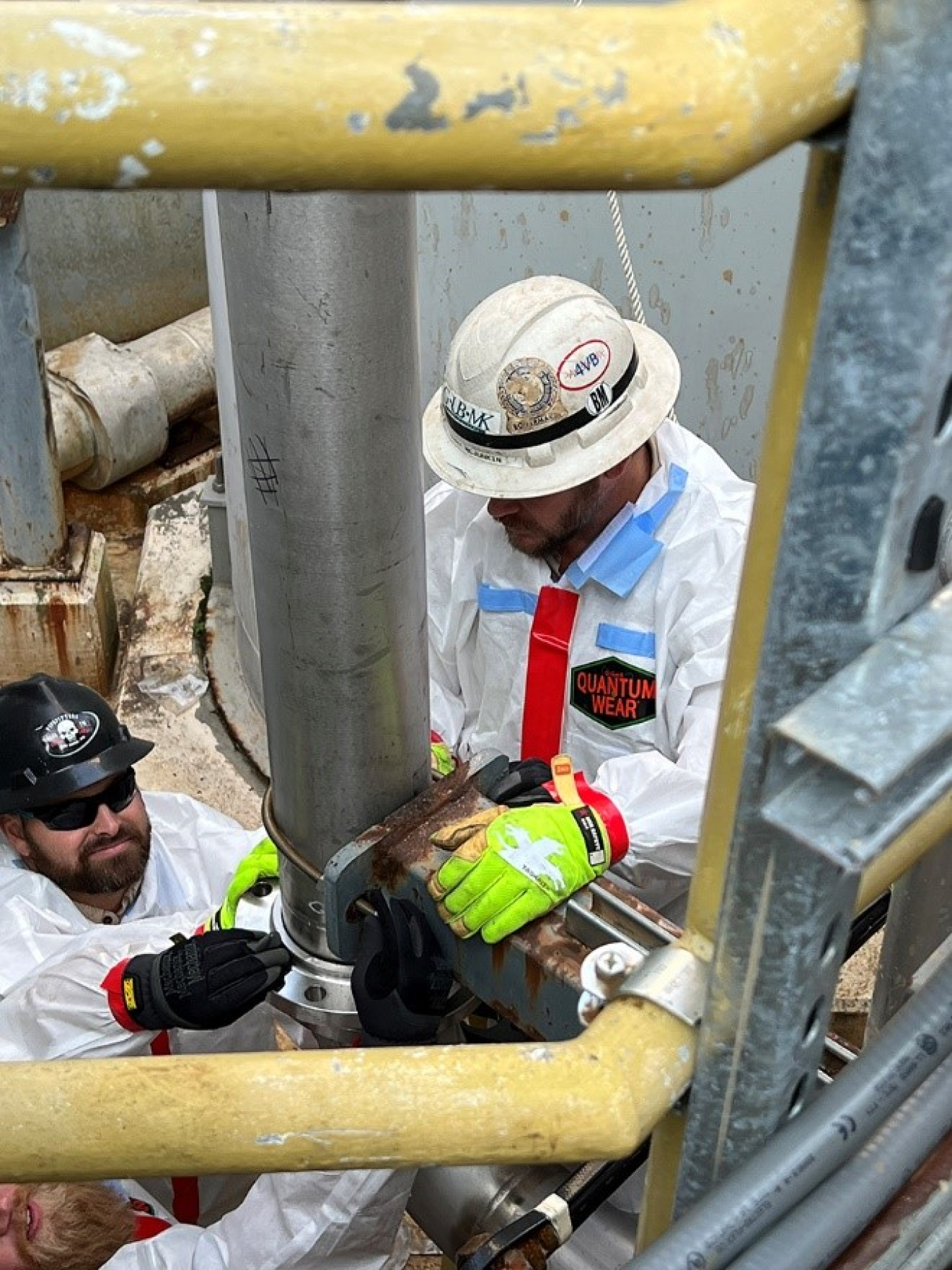 UCOR employees Eric Nicley, left, and Terry McJunkin address two sections of piping to prepare for winter weather at the 3609 Process Waste Treatment Facility