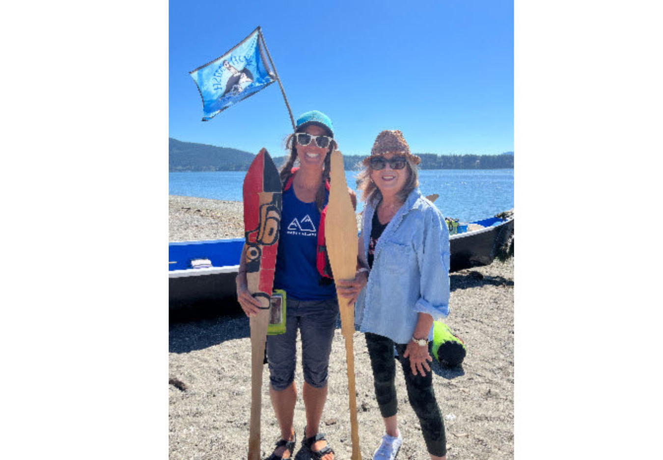 tephanie Bostwick carrying honor paddles standing next to another woman