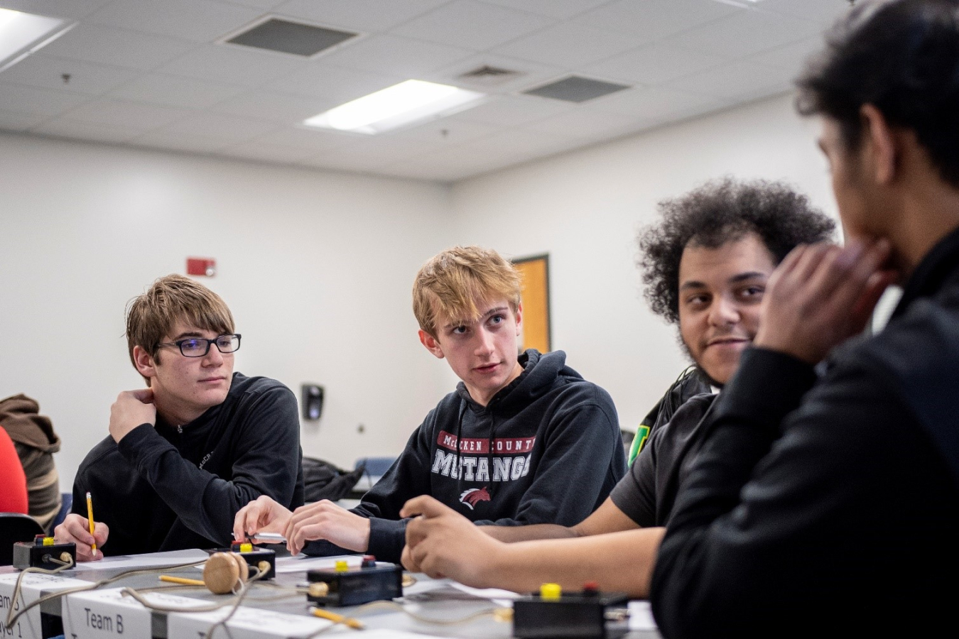 McCracken County High School students, from left, Colin McCurren, Garret Greenwell, Cole Cannon and Manav Shah consult with one another to answer questions during Friday’s DOE West Kentucky Regional Science Bowl.