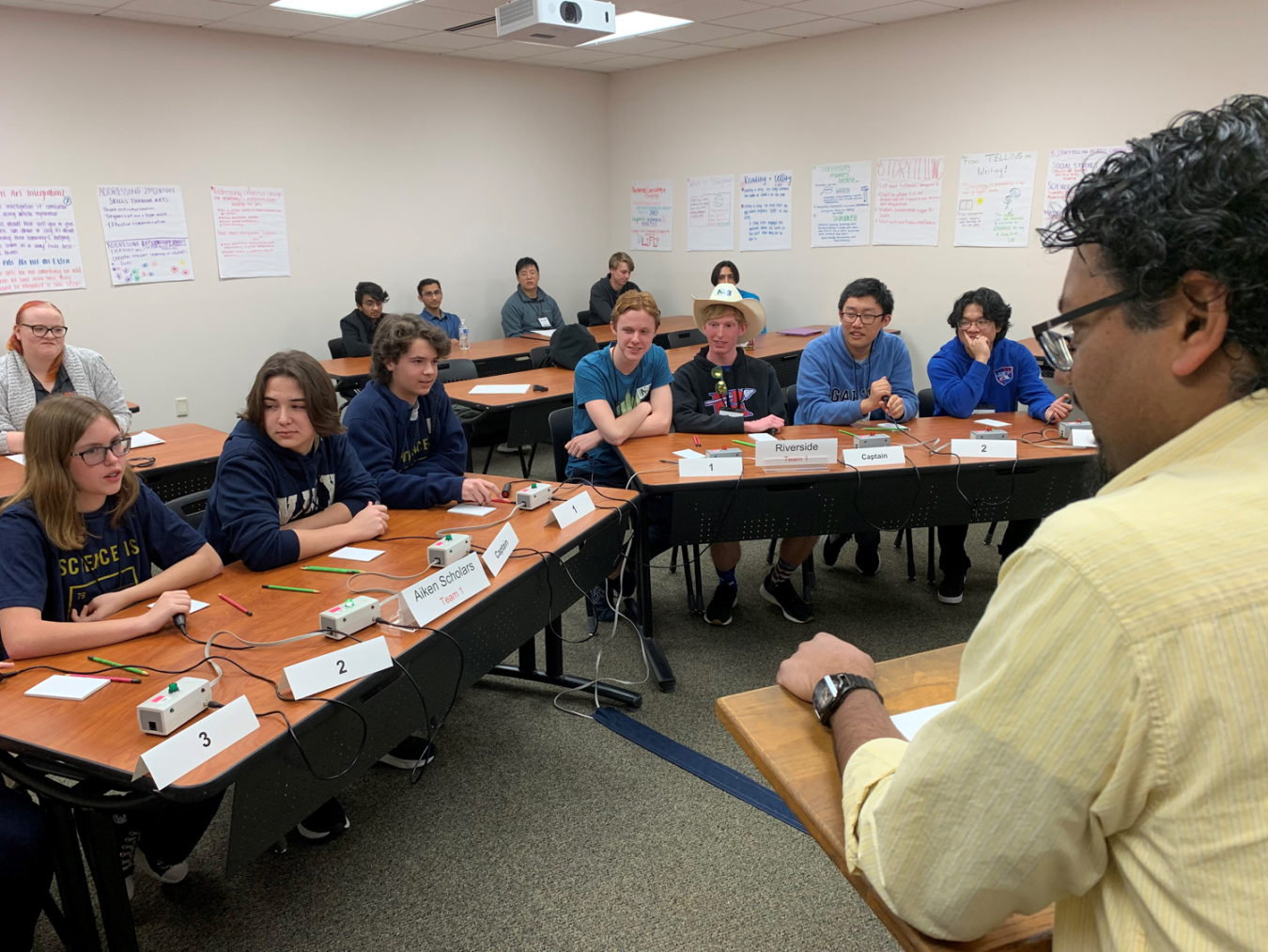 DOE Science Bowl teams from Aiken Scholars Academy in Aiken, South Carolina, foreground, and Riverside High School in Greer, SC, practice “buzzing in” to answer questions before another round of competition during the regional competition sponsored by DOE’s Savannah River Site.