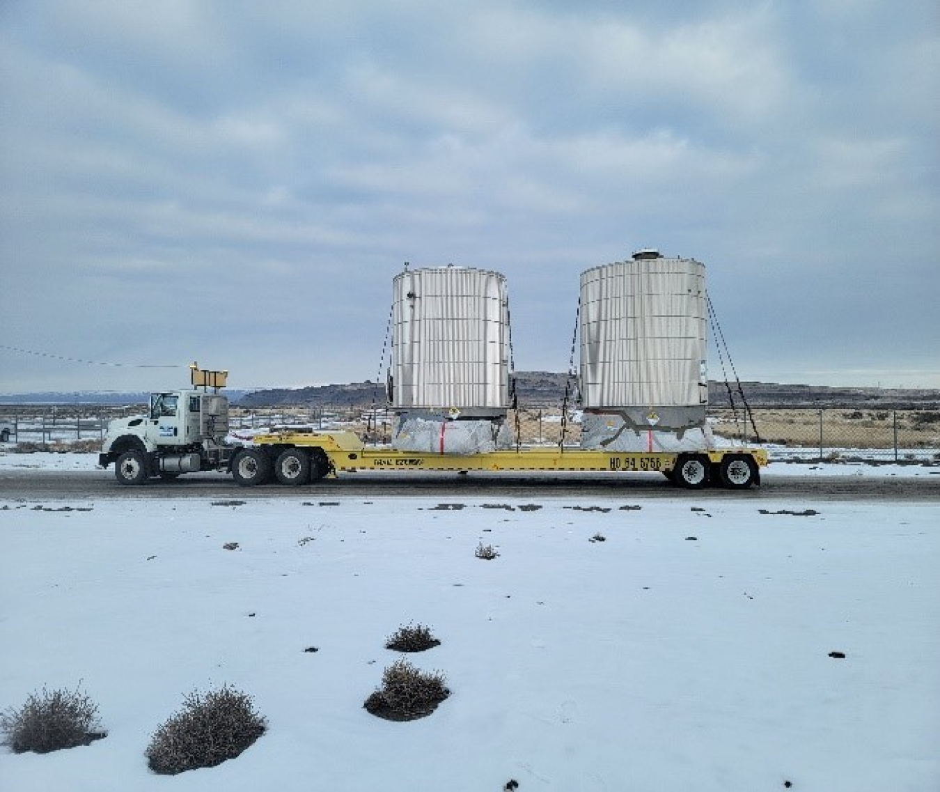 Hanford Mission Integration Solutions transports two empty tanks weighing more than five tons each from outside the Hanford Site’s Effluent Treatment Facility to an onsite landfill, making room for wastewater treatment work by EM Office of River Protection contractor Washington River Protection Solutions.