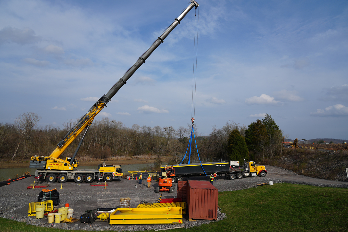 Workers use a 225-ton crane to lift a barge into Poplar Creek, where it helped transport workers and equipment to access a hard-to-reach cleanup area.