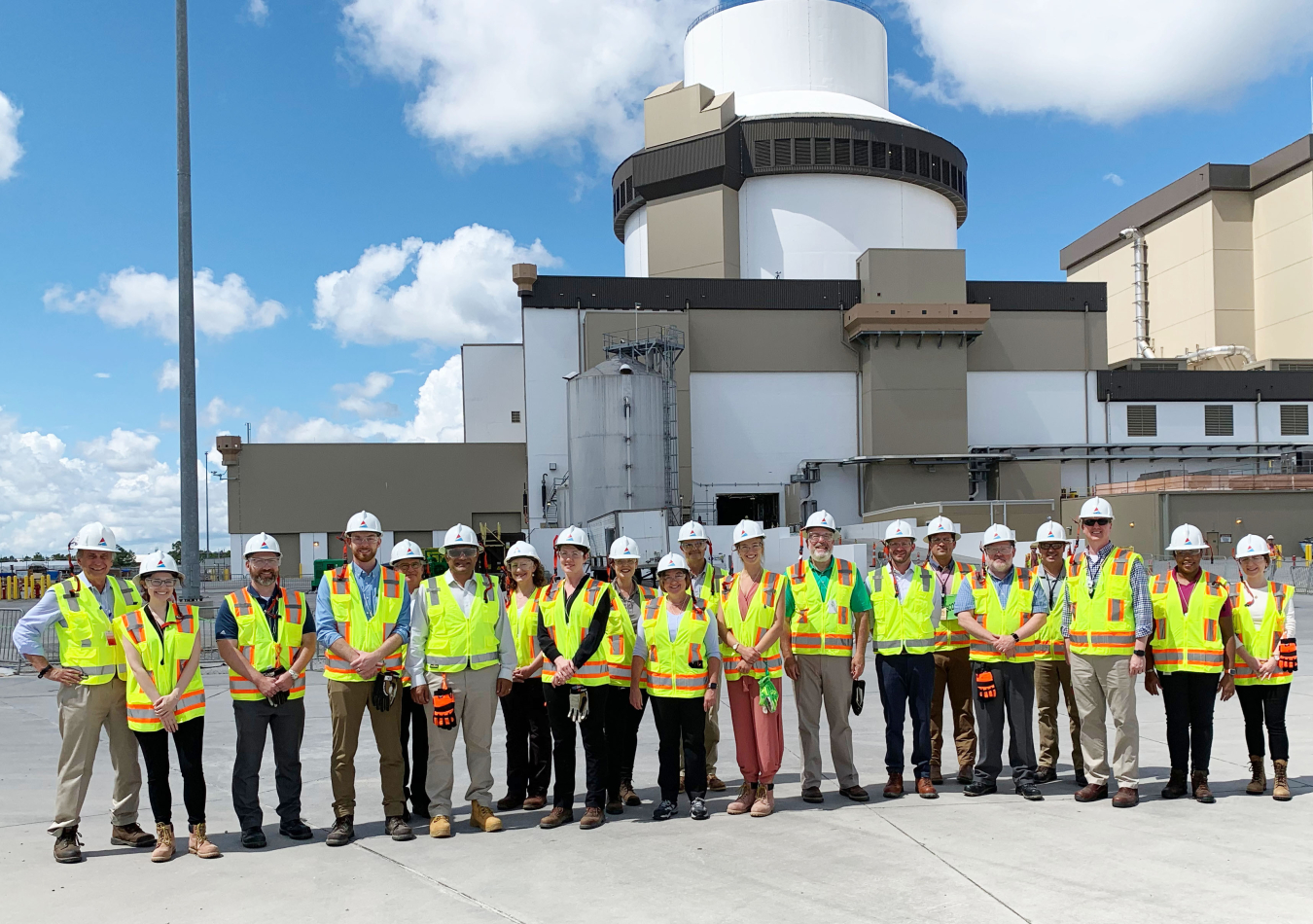 Photo of Jigar Shah standing outside with other officials from DOE and Georgia Power at Plant Vogtle