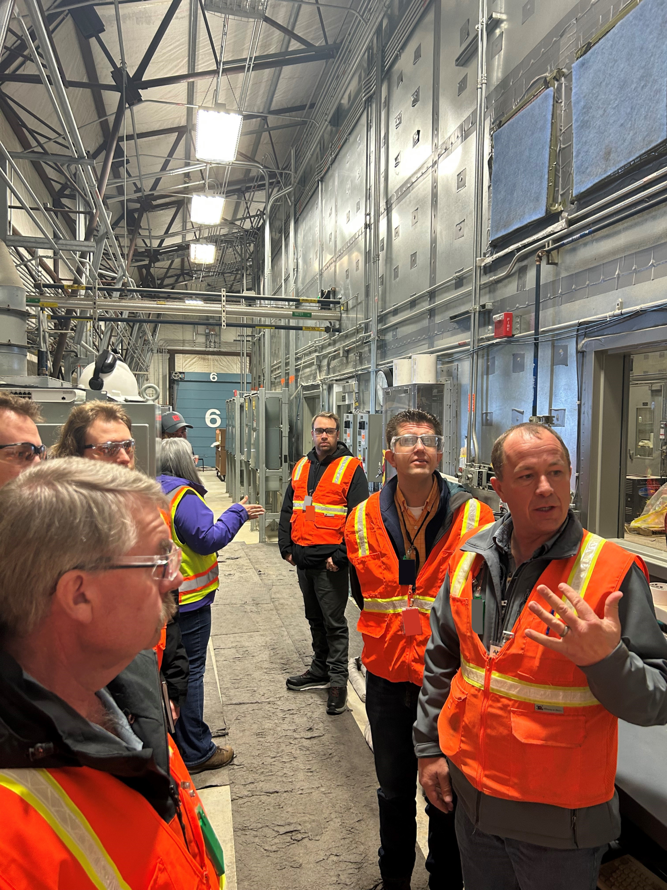 Jason Chapple, bottom right, Idaho Environmental Coalition (IEC) director of Accelerated Retrieval Project (ARP) Operations and Remediation, discusses preparations for demolition of one of the ARP enclosures with a delegation from the Canadian Nuclear Laboratories (CNL) recently. CNL will demolish several facilities as part of a larger cleanup mission at the Chalk River and Whiteshell laboratories. During its visit to the Idaho National Laboratory Site, the Canadian delegation met with IEC directors and sta