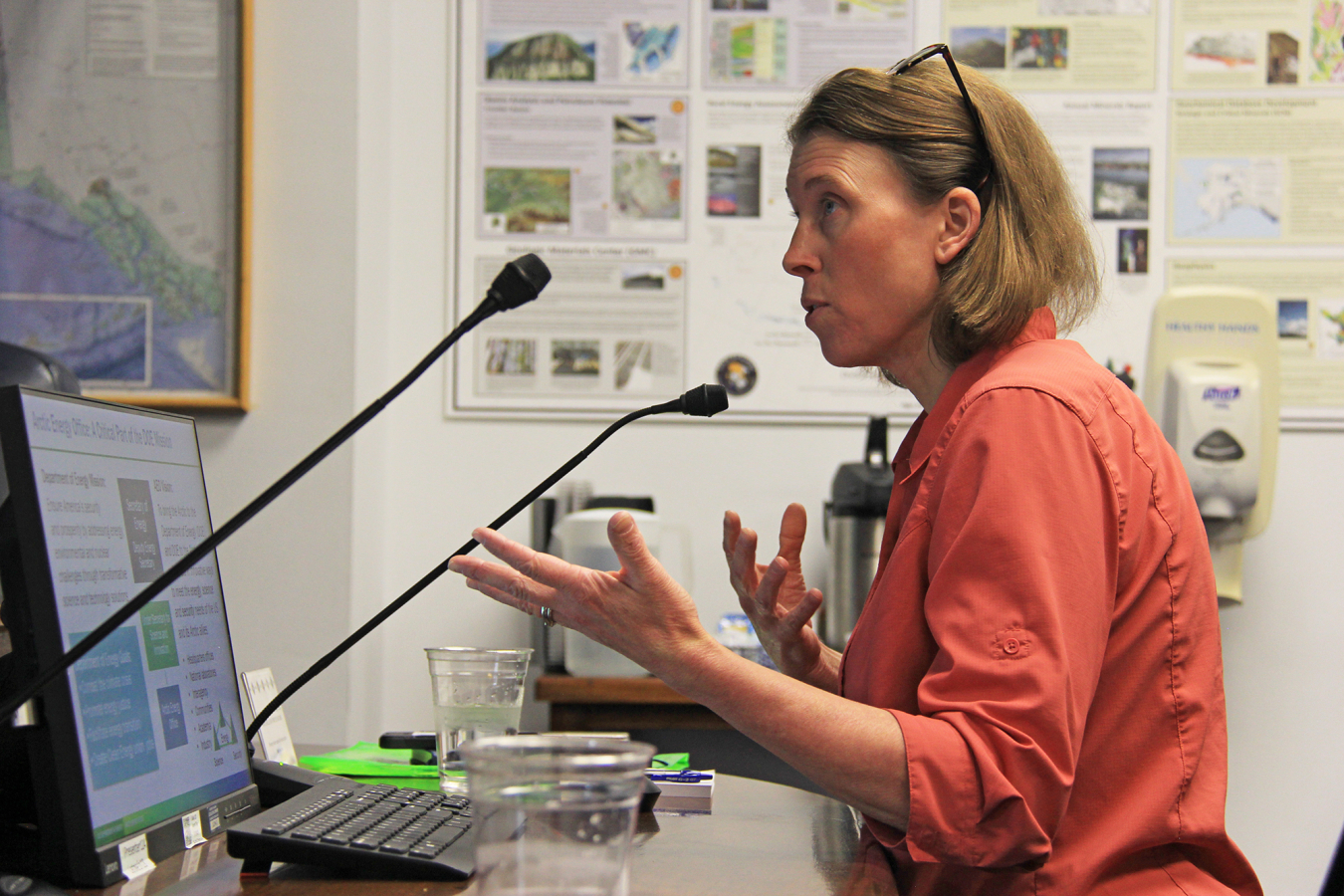 Dr. Erin Whitney speaks into a microphone to the House Transportation Committee at the Alaska State Legislature. 